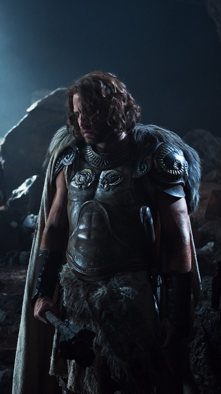 Mann in Schwarzer Lederjacke Steht Auf Felsen. Wallpaper in 750x1334 Resolution