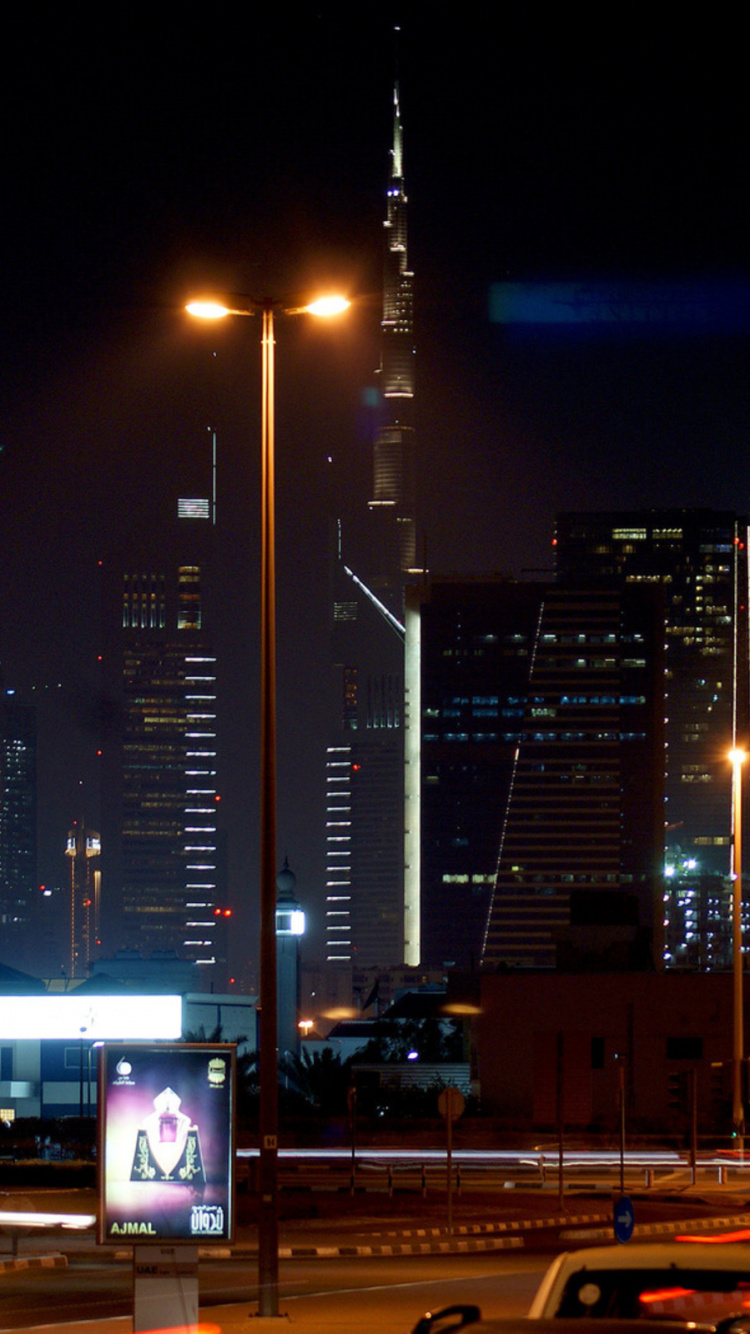 Cars on Road Near City Buildings During Night Time. Wallpaper in 750x1334 Resolution