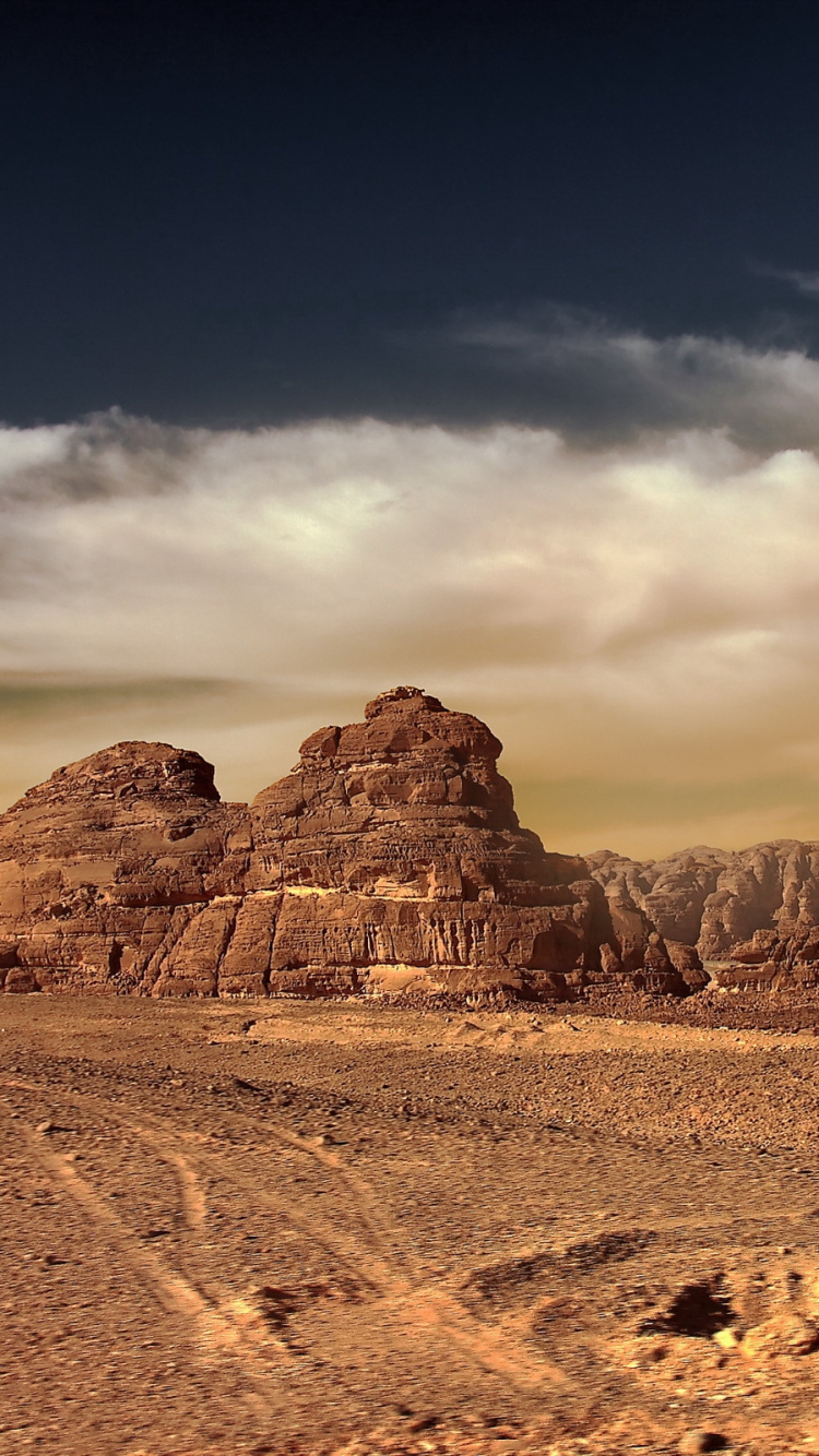 Brown Rocky Mountain Under Cloudy Sky During Daytime. Wallpaper in 750x1334 Resolution