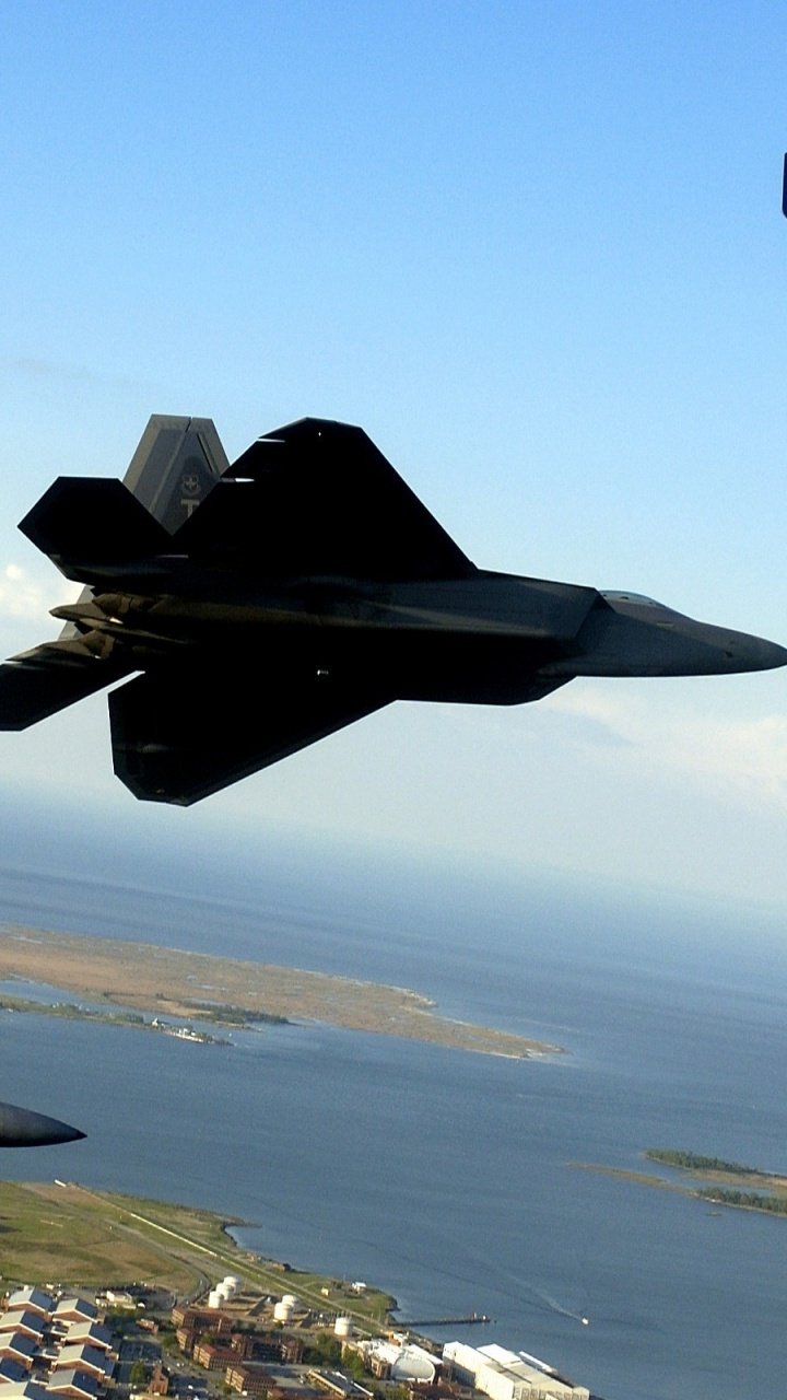 Black Jet Plane Flying Over City During Daytime. Wallpaper in 720x1280 Resolution