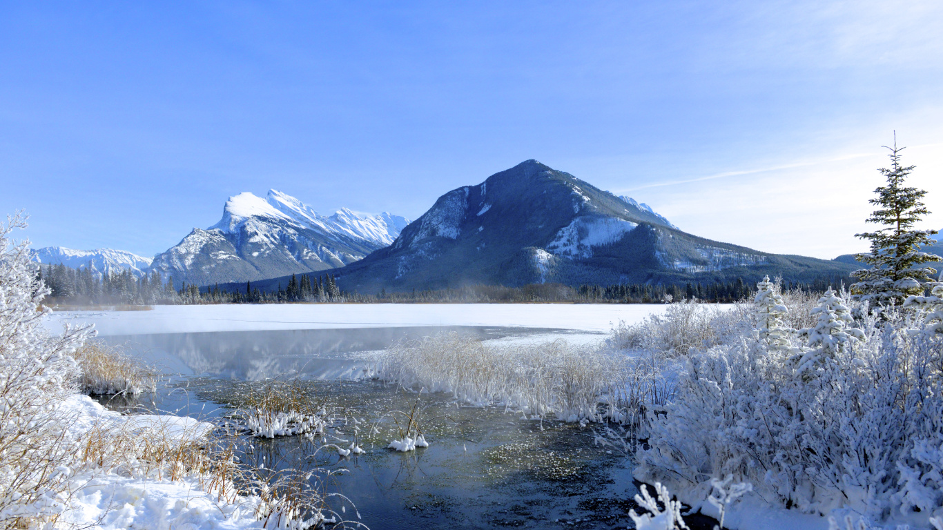Snow Covered Mountain Near Lake Under Blue Sky During Daytime. Wallpaper in 1366x768 Resolution