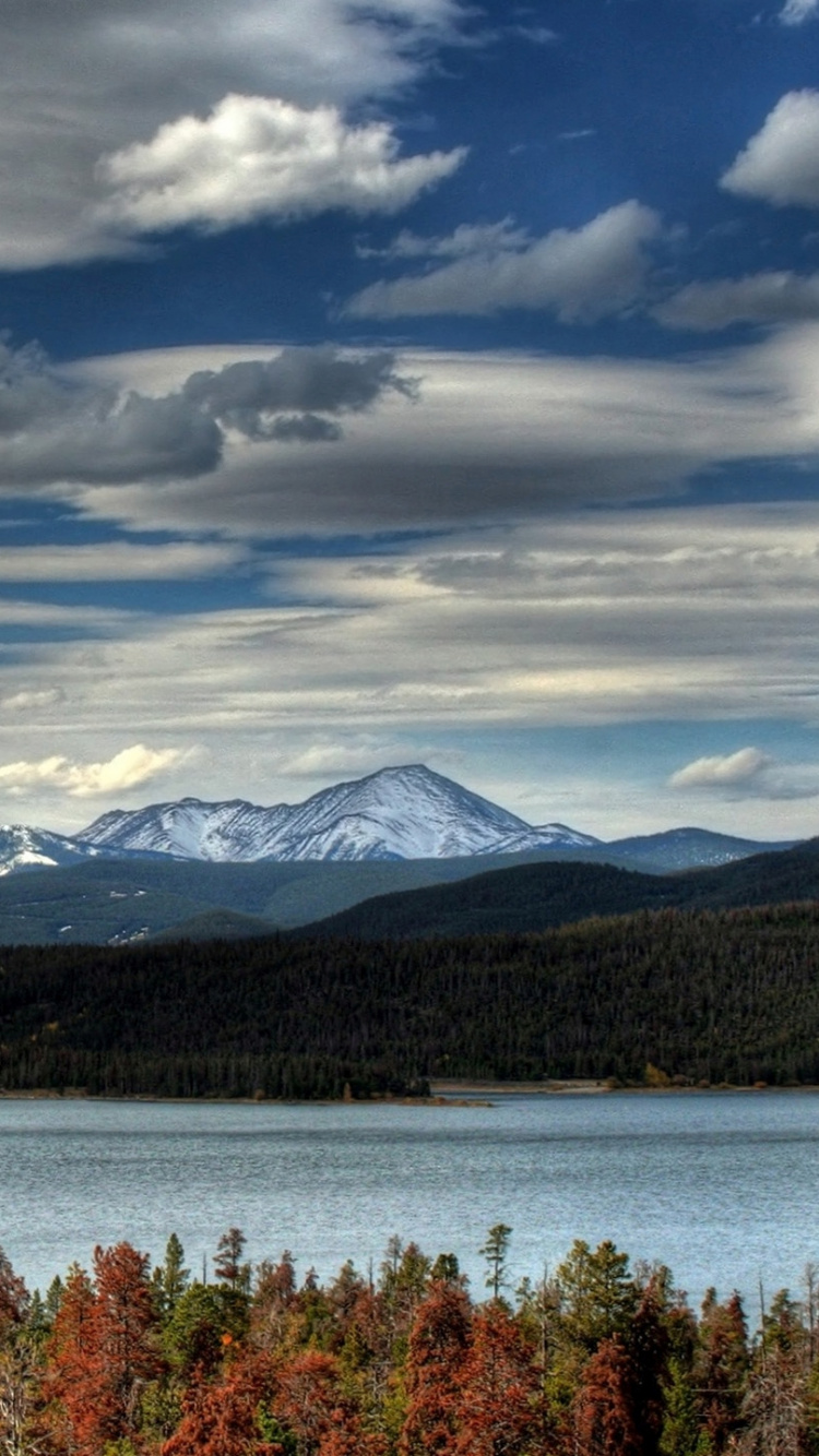 Lake Near Mountain Under Cloudy Sky During Daytime. Wallpaper in 750x1334 Resolution