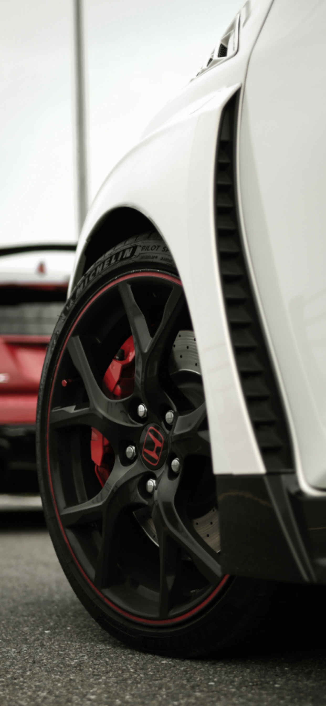 Weißes Auto Auf Grauer Asphaltstraße. Wallpaper in 1242x2688 Resolution