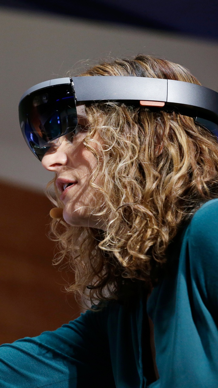 Woman in Blue Shirt Wearing White and Black Headphones. Wallpaper in 720x1280 Resolution