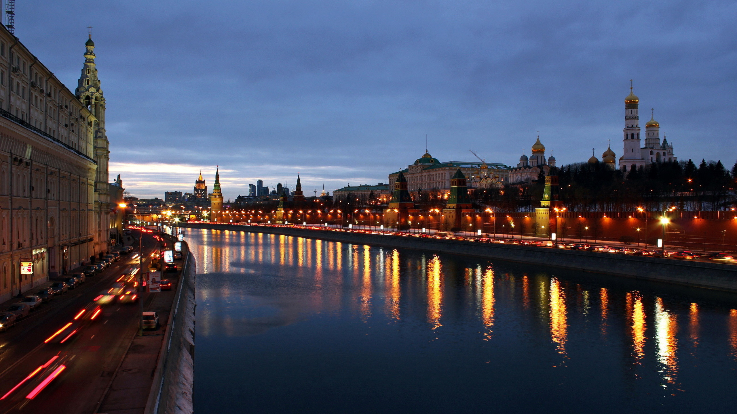 City Skyline Across Body of Water During Night Time. Wallpaper in 2560x1440 Resolution