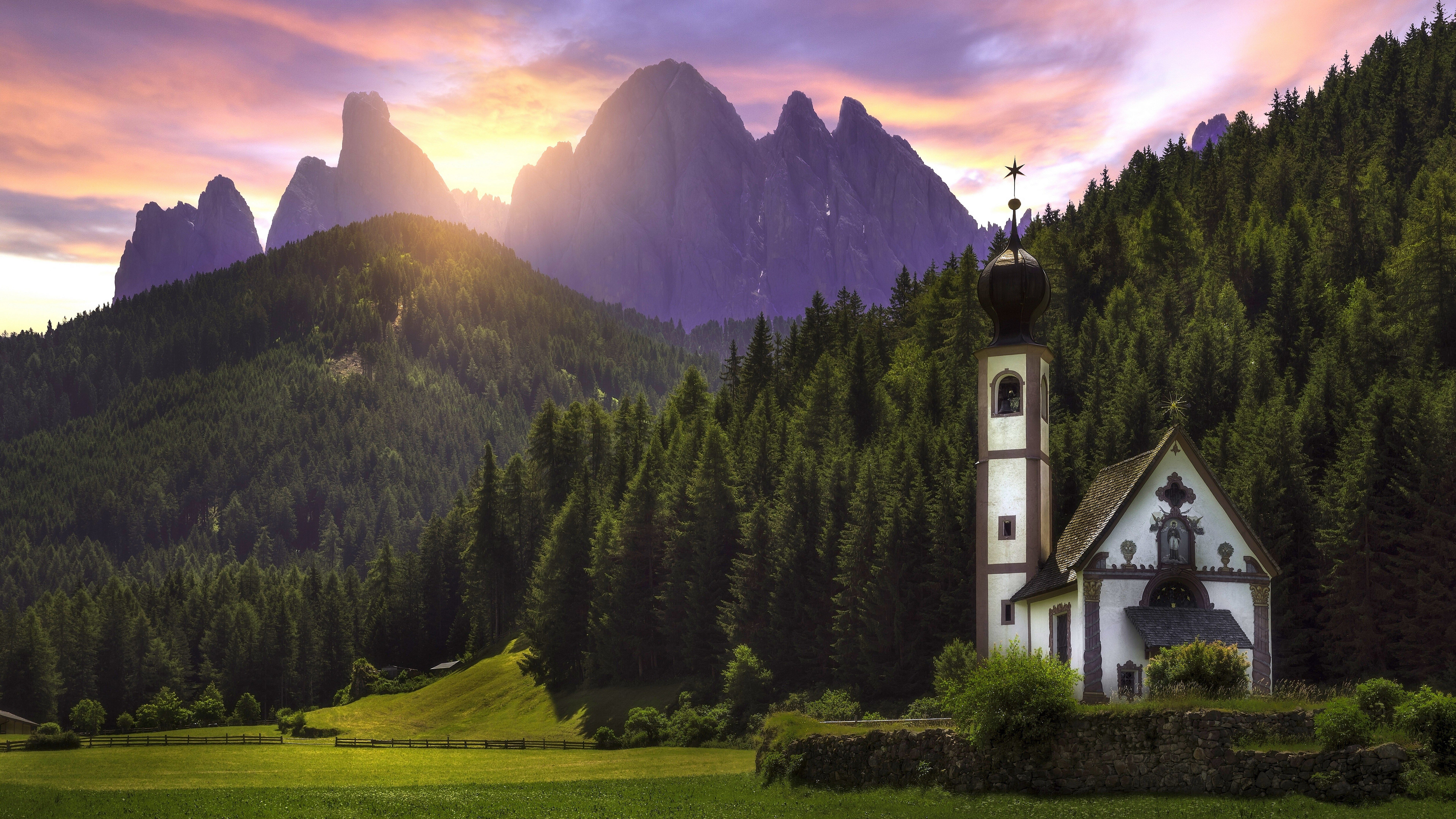 White and Black Church on Green Grass Field Near Green Trees and Mountains During Daytime. Wallpaper in 7680x4320 Resolution