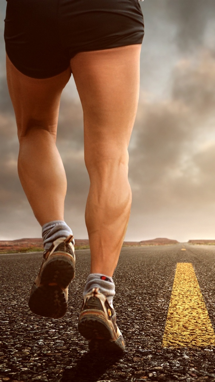 Person in Black Shorts and Black and White Sneakers Running on Black Asphalt Road During Daytime. Wallpaper in 720x1280 Resolution