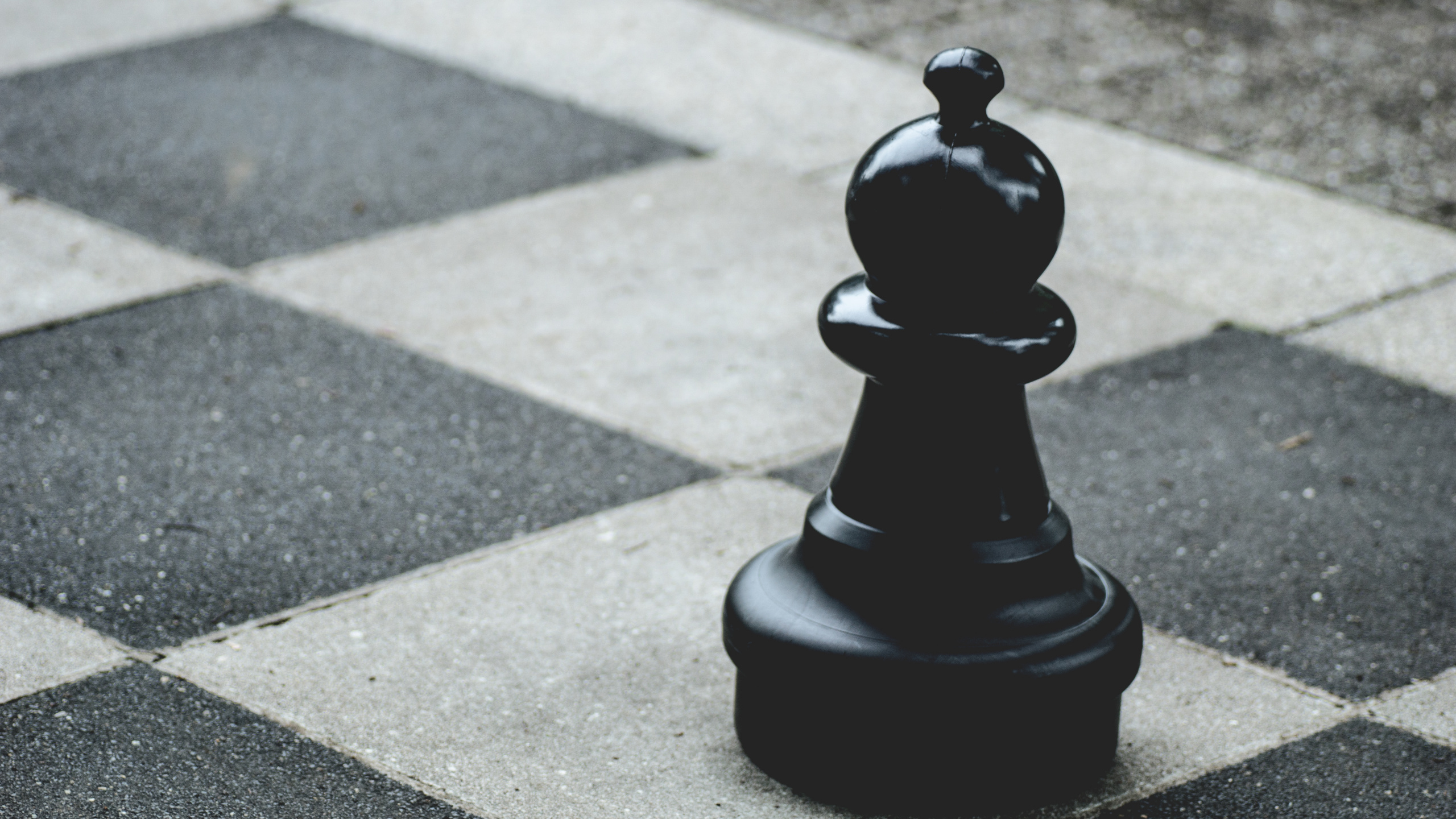 Download 2560x1440 Wallpaper Black Chess Piece on Gray Concrete Pavement Black Chess Piece on Gray Concrete Pavement. Wallpaper in 2560x1440 Resolution