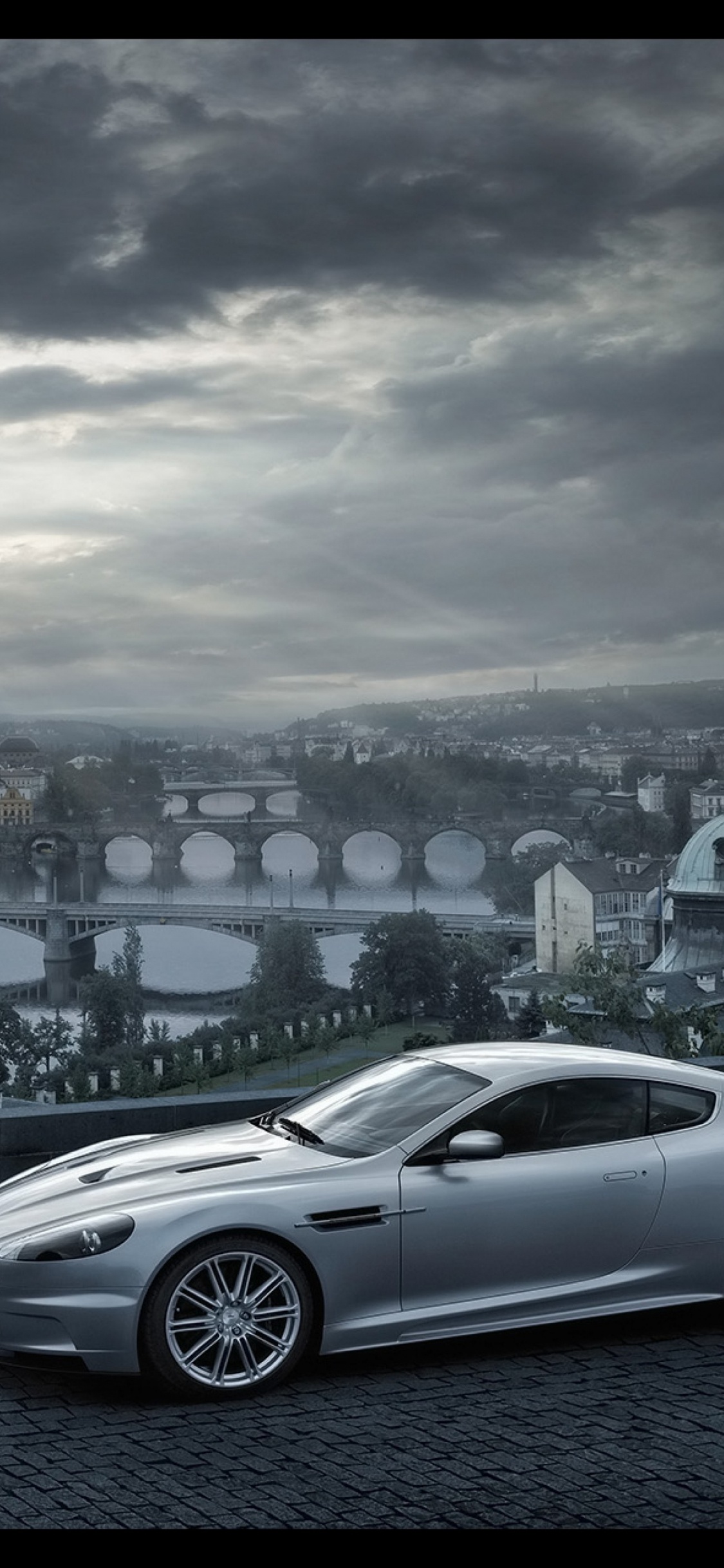 Silver Sedan on Road Near City Buildings During Daytime. Wallpaper in 1125x2436 Resolution