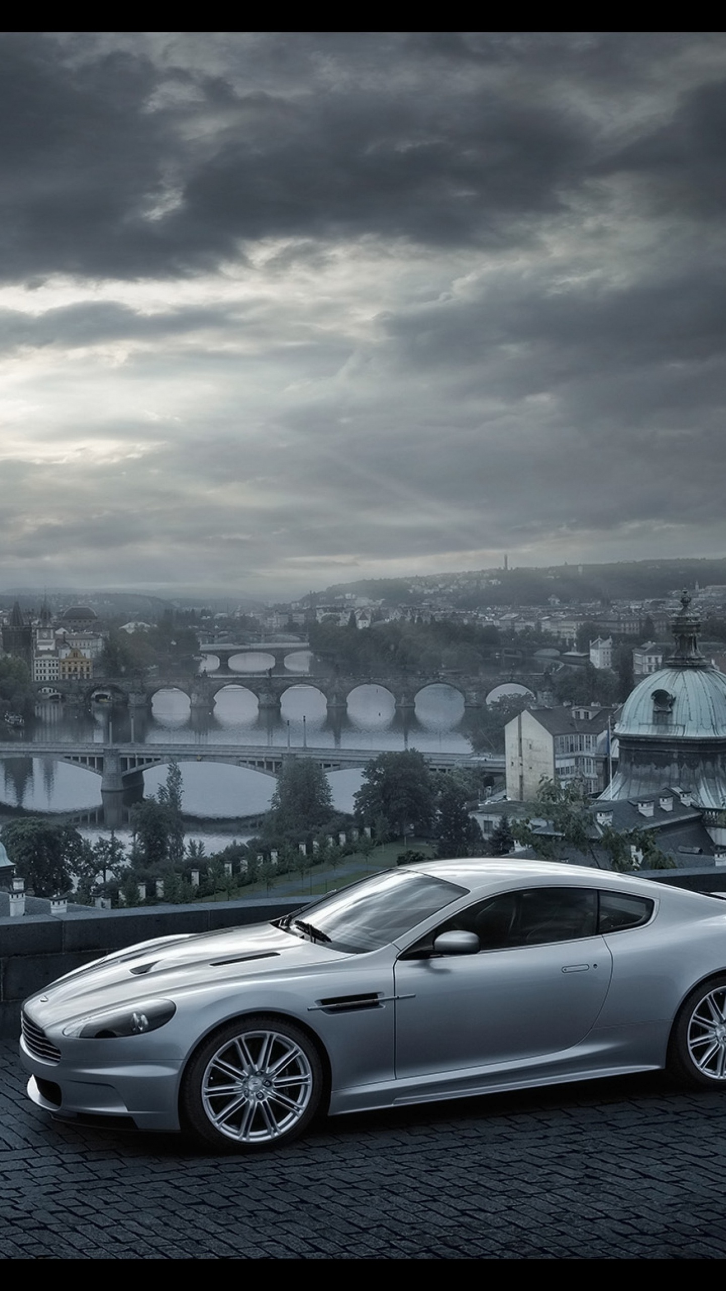 Silver Sedan on Road Near City Buildings During Daytime. Wallpaper in 1440x2560 Resolution