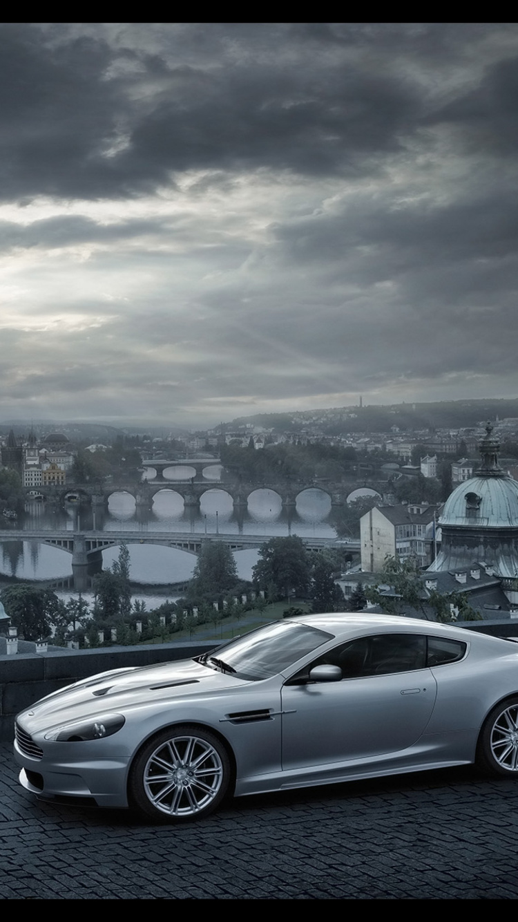 Silver Sedan on Road Near City Buildings During Daytime. Wallpaper in 750x1334 Resolution