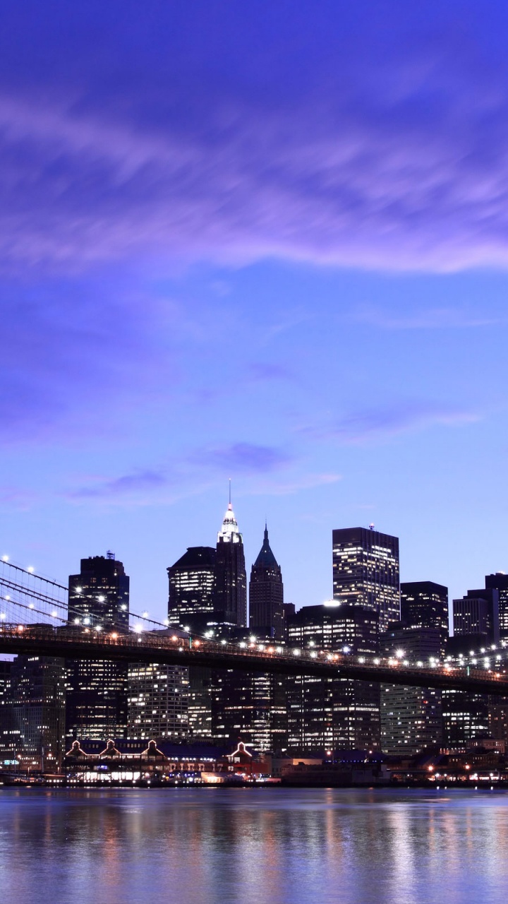 City Skyline Across Body of Water During Night Time. Wallpaper in 720x1280 Resolution