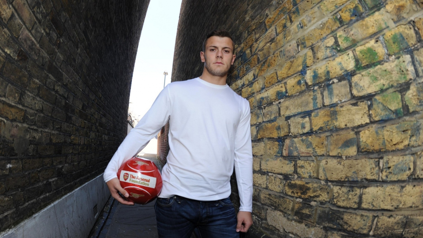 Man in White Crew Neck Long Sleeve Shirt Holding White and Red Soccer Ball. Wallpaper in 1366x768 Resolution