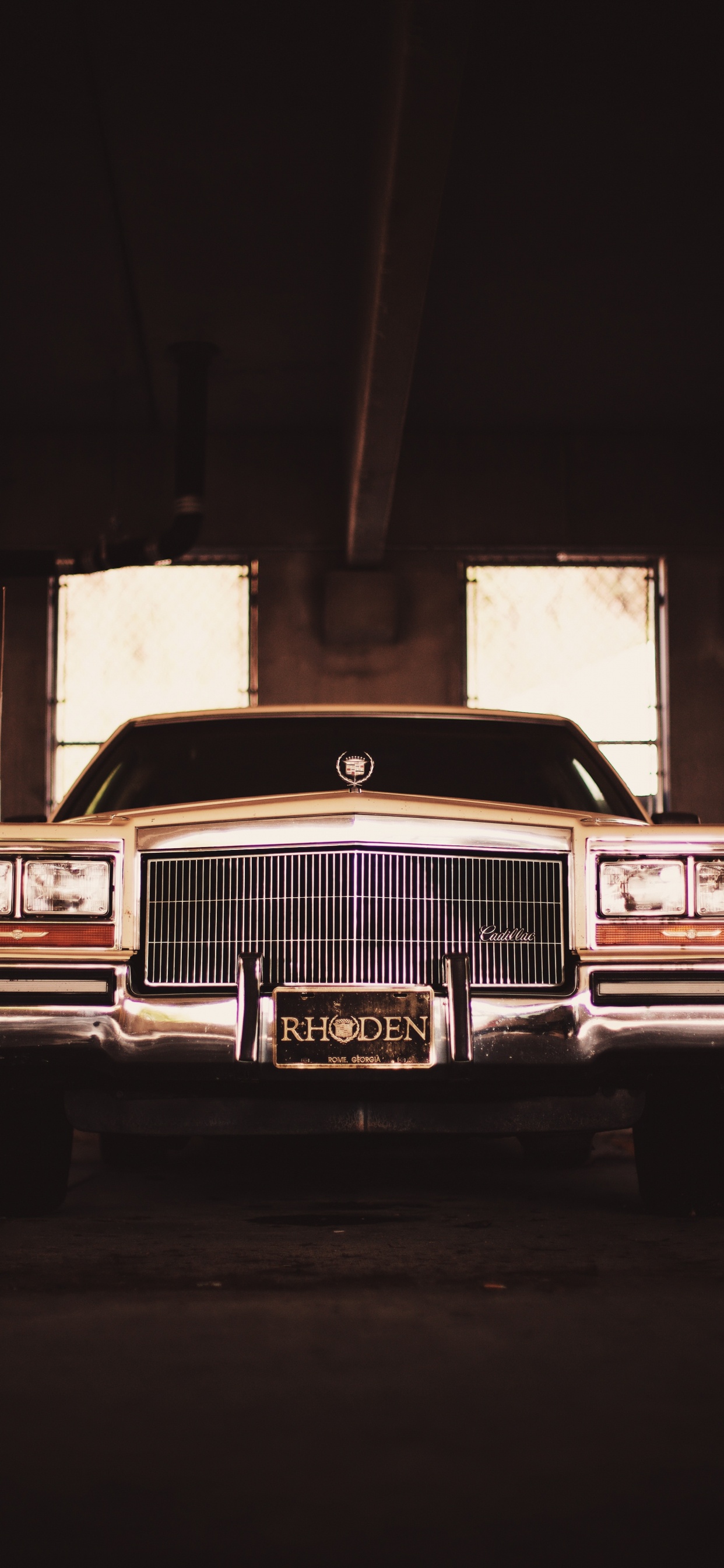 Classic Brown Car in a Garage. Wallpaper in 1242x2688 Resolution