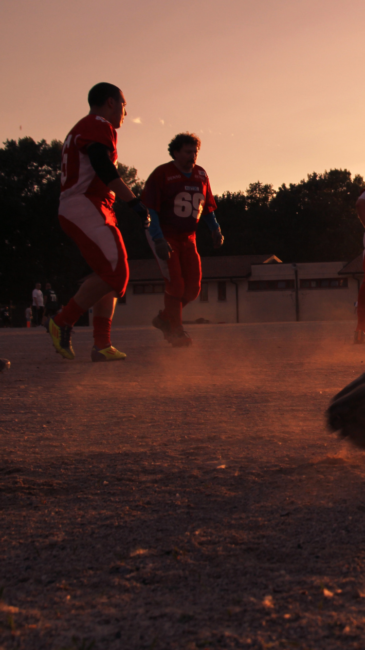 Gente Saltando en el Campo Marrón Durante el Día. Wallpaper in 750x1334 Resolution