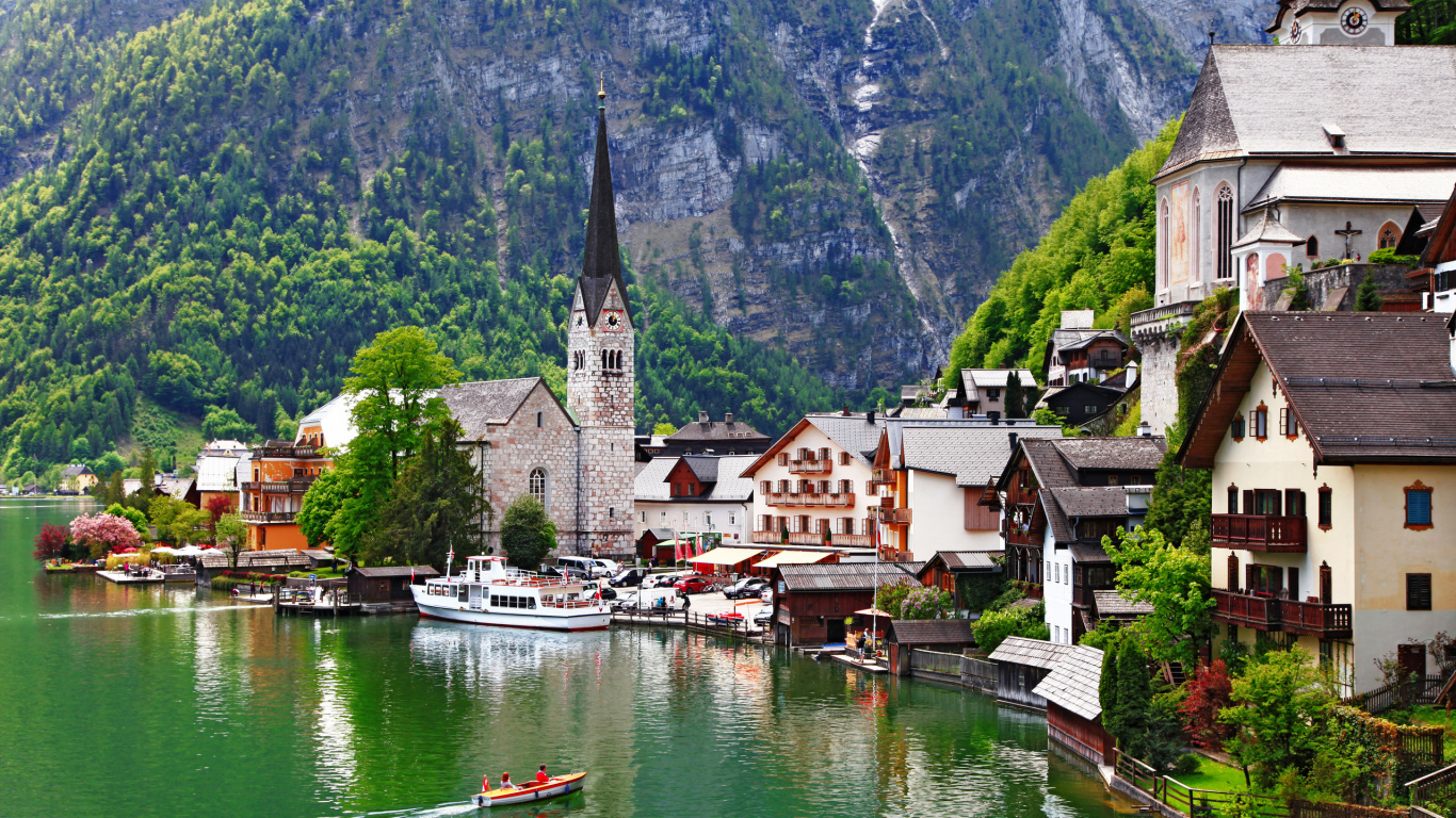 White and Brown Concrete Building Beside Body of Water During Daytime. Wallpaper in 1366x768 Resolution