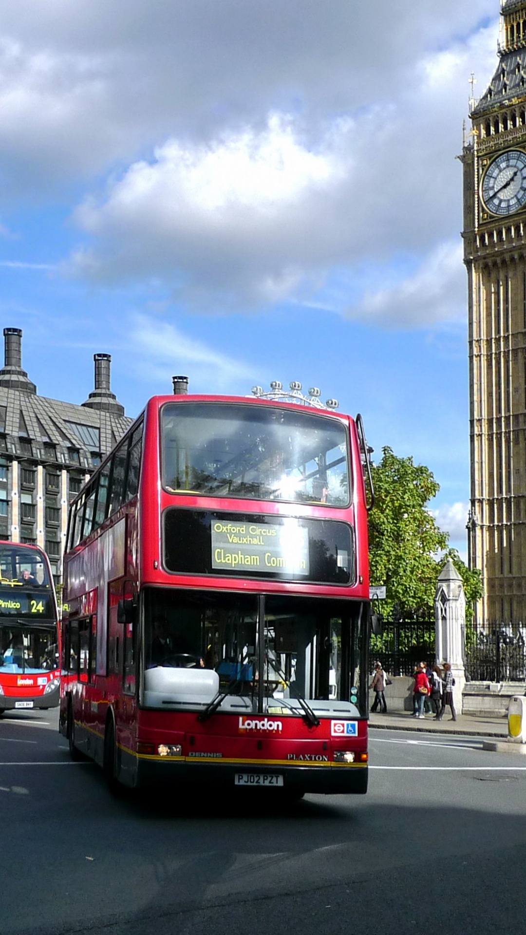 Red Double Decker Bus on Road Near Brown Concrete Building During Daytime. Wallpaper in 1080x1920 Resolution