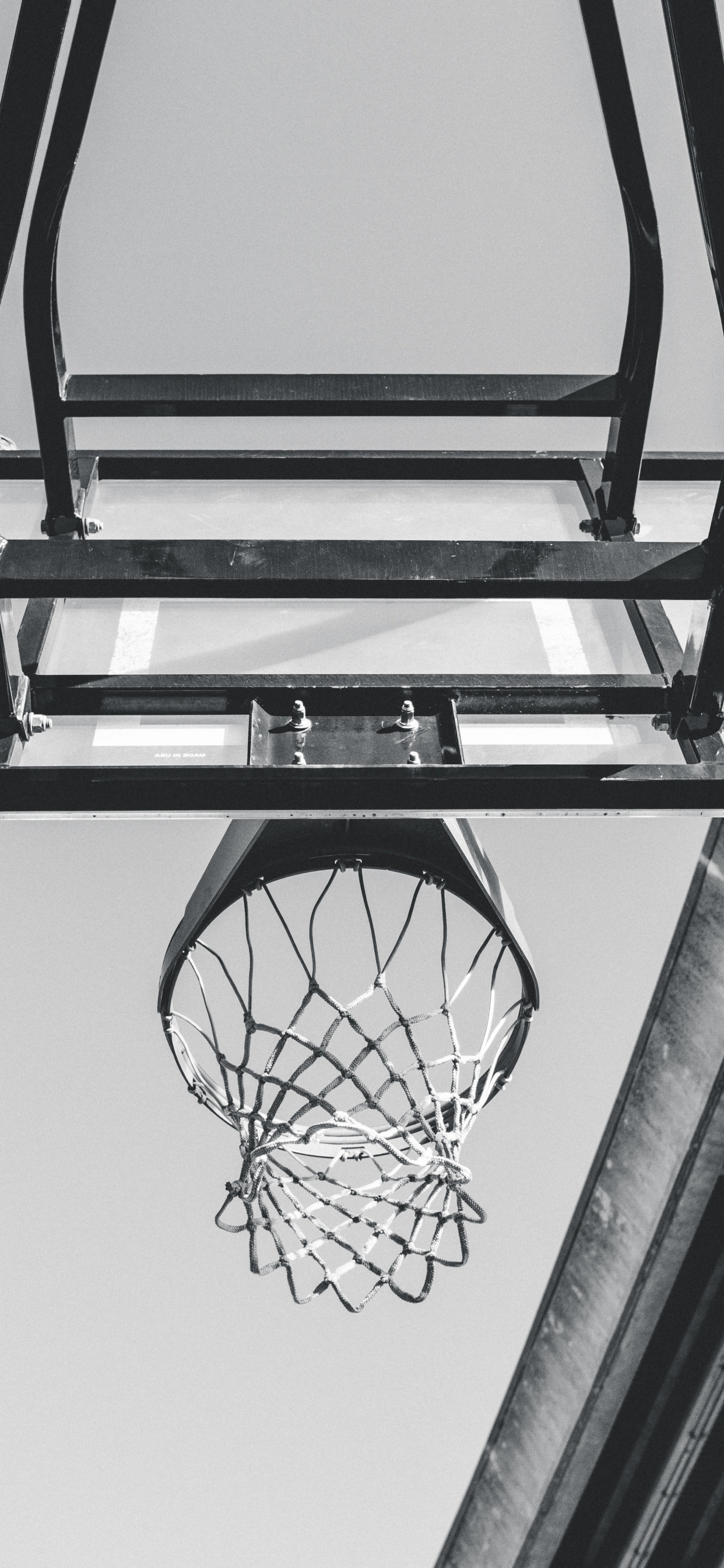 Black Basketball Hoop on White Wall. Wallpaper in 1242x2688 Resolution
