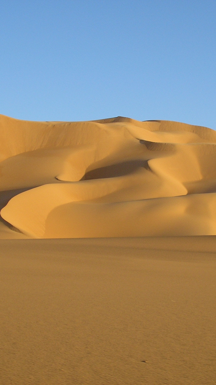 Brown Sand Dunes Under Blue Sky During Daytime. Wallpaper in 750x1334 Resolution