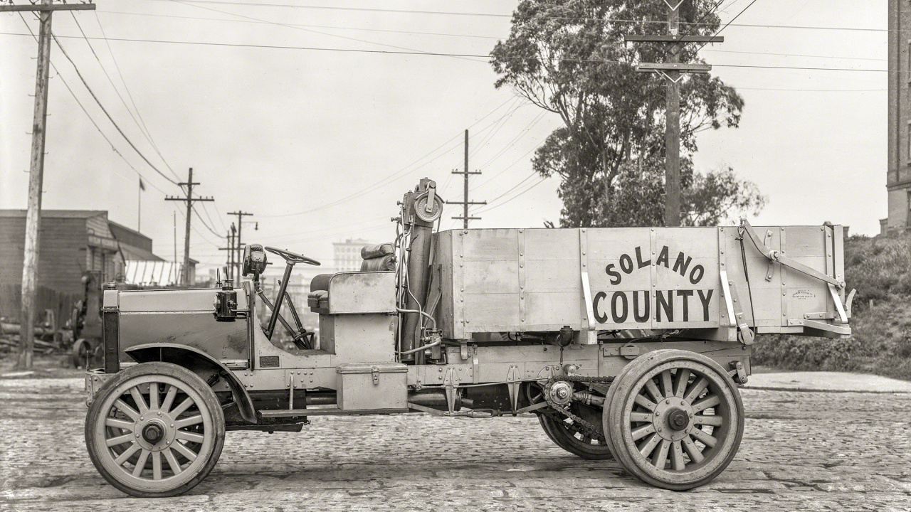 Grayscale Photo of a Trailer Truck Parked Near Trees. Wallpaper in 1280x720 Resolution