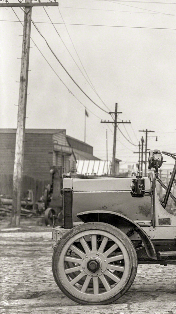 Grayscale Photo of a Trailer Truck Parked Near Trees. Wallpaper in 720x1280 Resolution