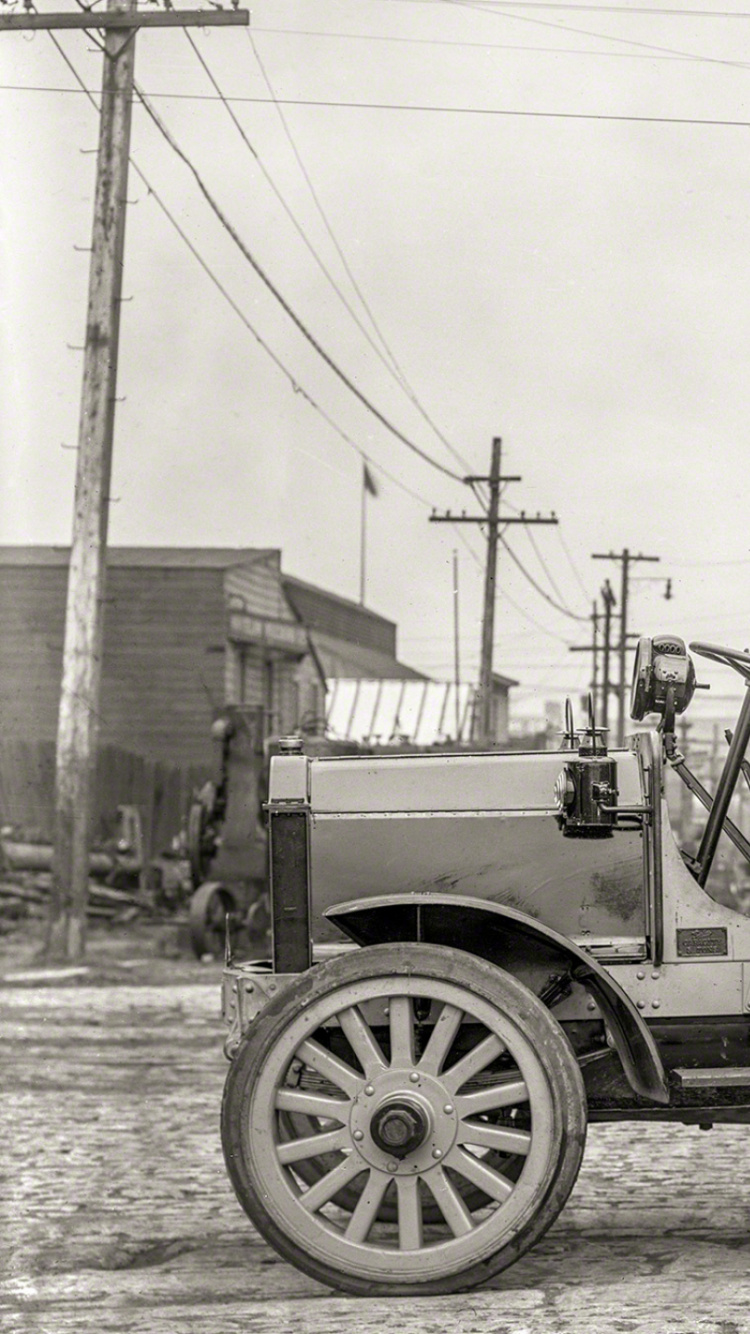 Grayscale Photo of a Trailer Truck Parked Near Trees. Wallpaper in 750x1334 Resolution