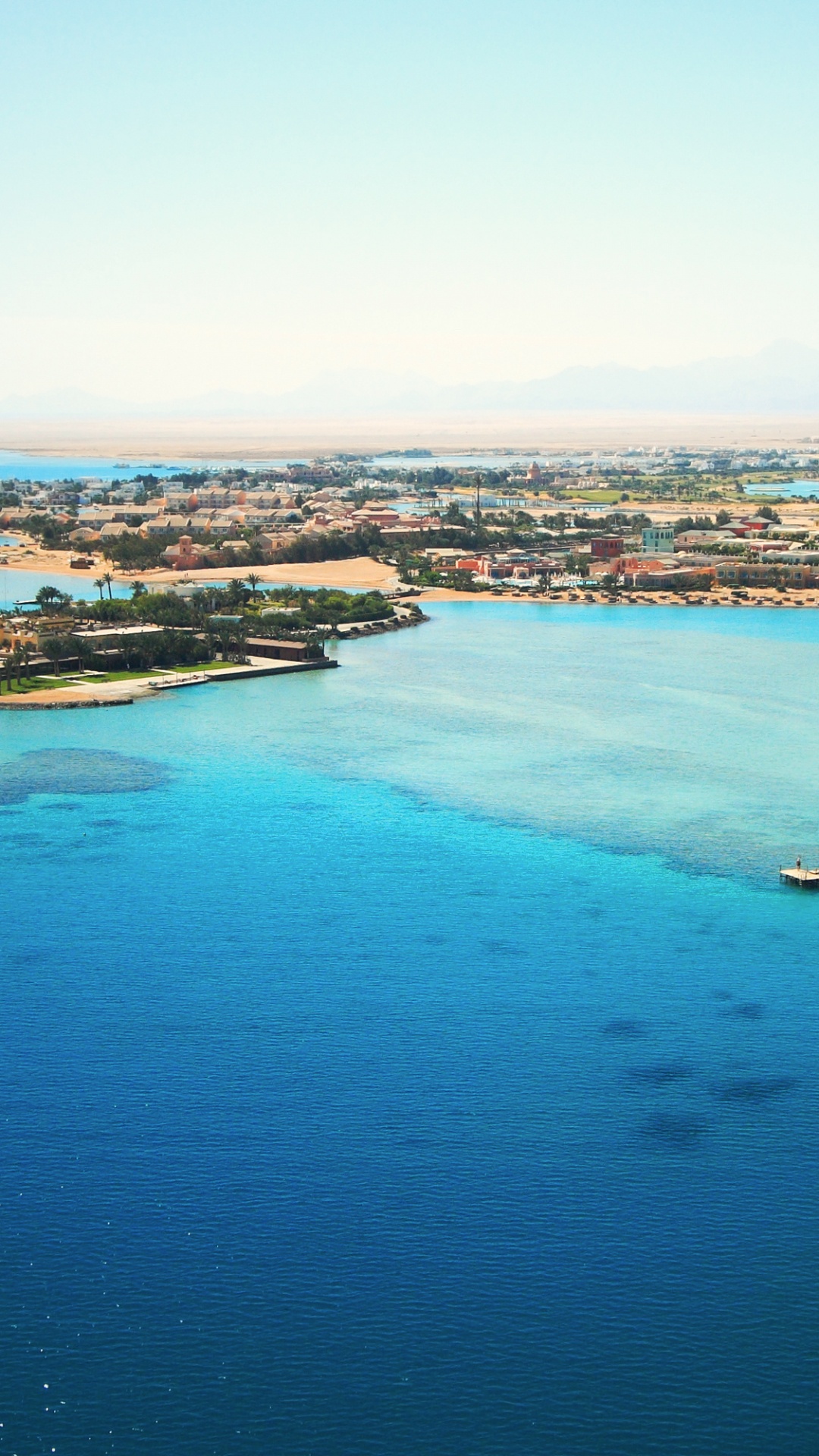 Vista Aérea de Los Edificios de la Ciudad Cerca Del Cuerpo de Agua Durante el Día.. Wallpaper in 1080x1920 Resolution