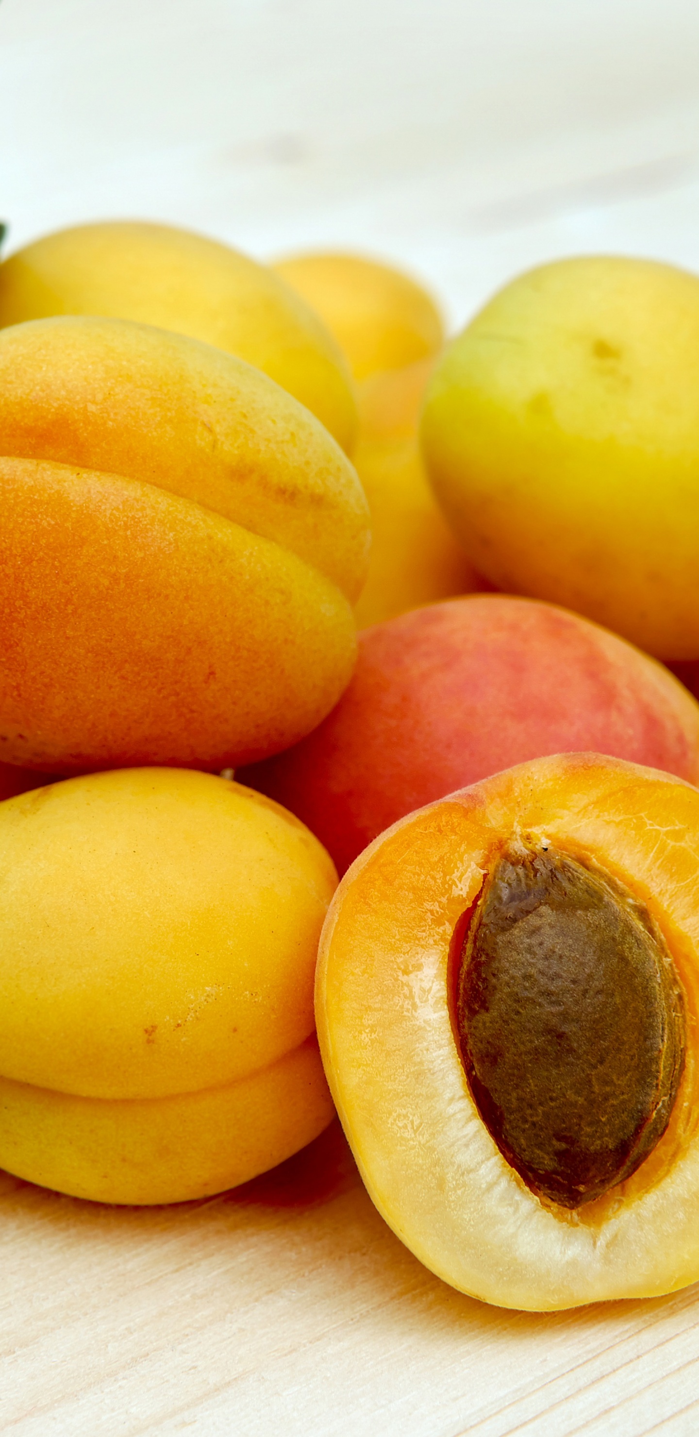 Yellow Round Fruits on White Table. Wallpaper in 1440x2960 Resolution