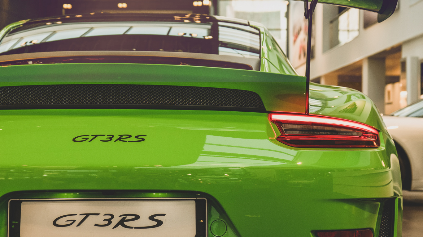 Green Porsche 911 Parked in Front of Building. Wallpaper in 1366x768 Resolution