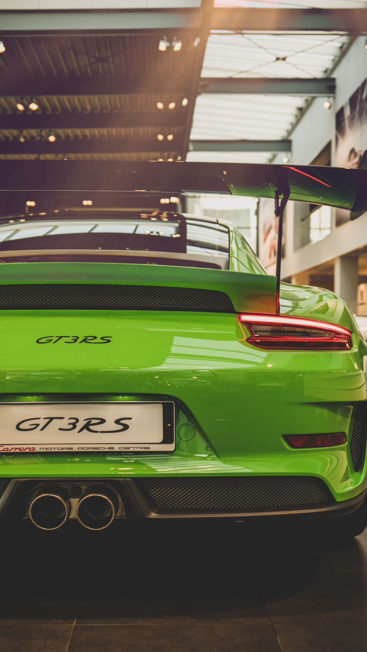 Green Porsche 911 Parked in Front of Building. Wallpaper in 750x1334 Resolution
