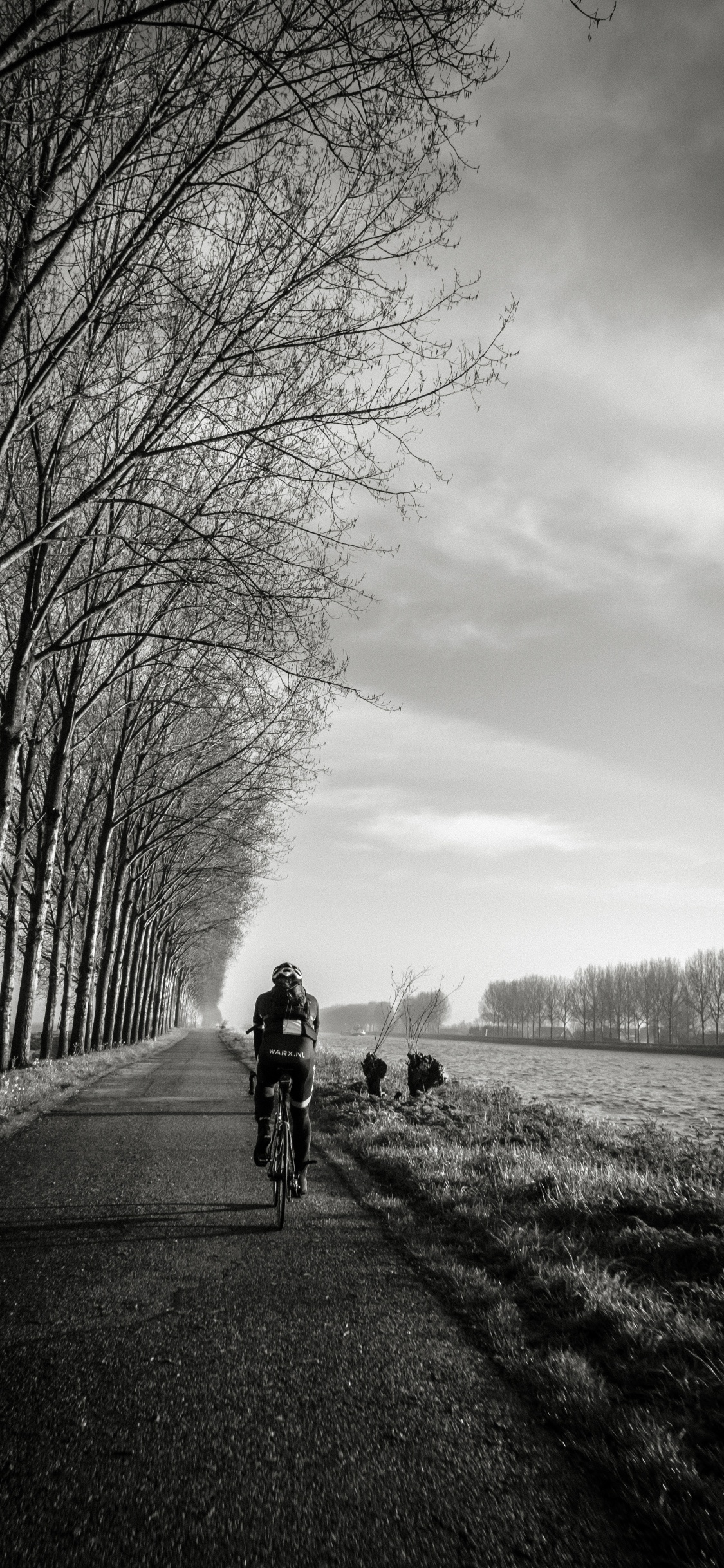 Foto en Escala de Grises de 2 Hombres Montando Bicicleta en la Carretera. Wallpaper in 1125x2436 Resolution