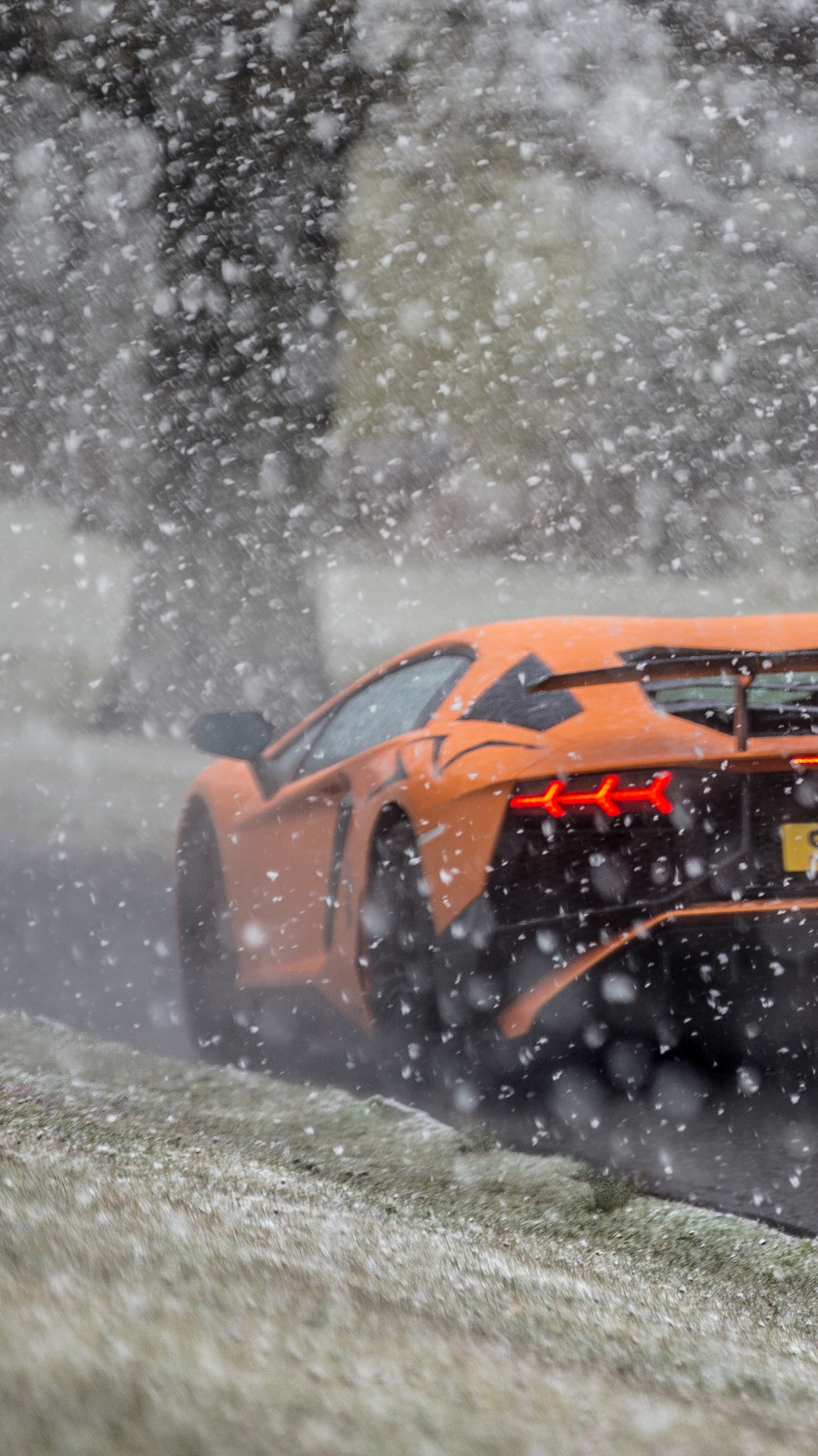 Yellow and Black Sports Car on Snow Covered Ground. Wallpaper in 1080x1920 Resolution