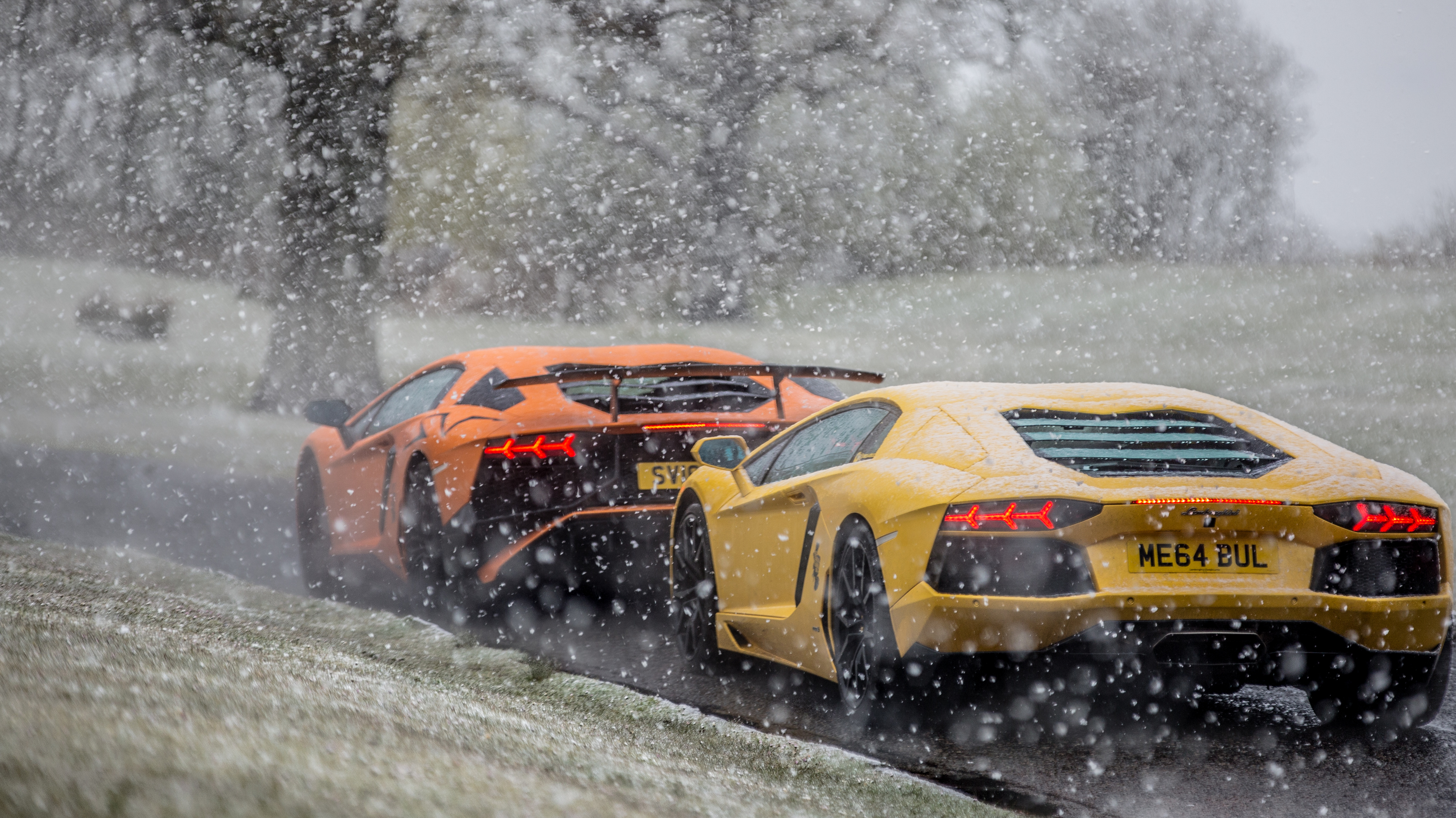 Yellow and Black Sports Car on Snow Covered Ground. Wallpaper in 3840x2160 Resolution
