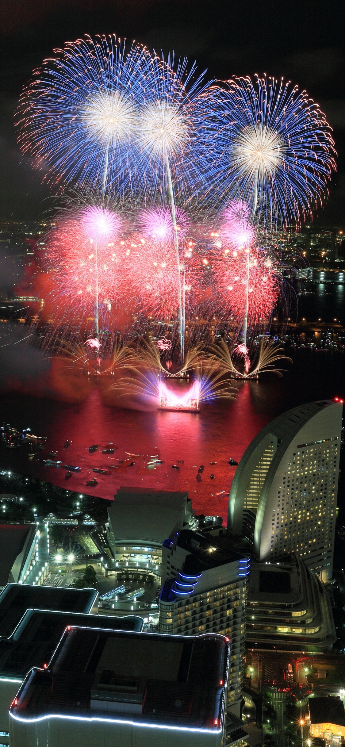City With High Rise Buildings During Night Time. Wallpaper in 1125x2436 Resolution