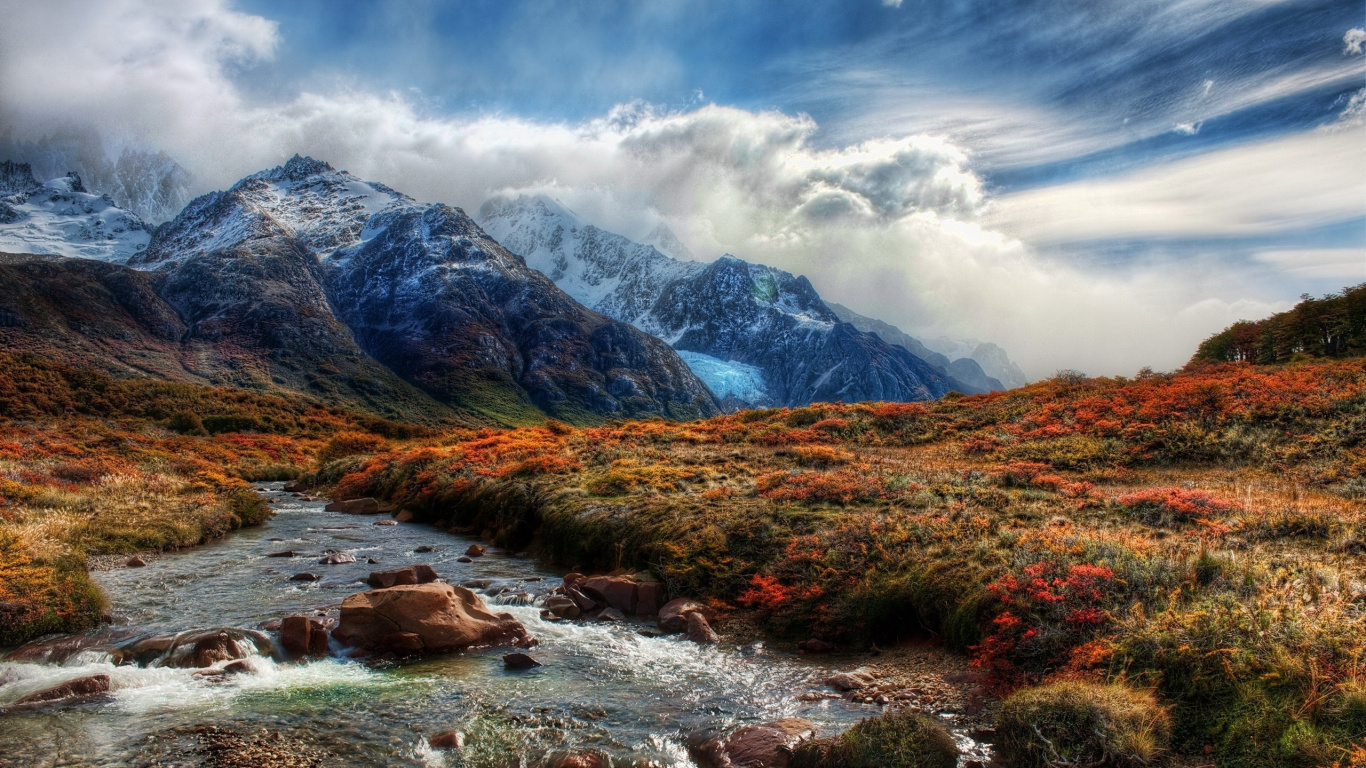 Green Grass Field Near Mountain Under White Clouds During Daytime. Wallpaper in 1366x768 Resolution