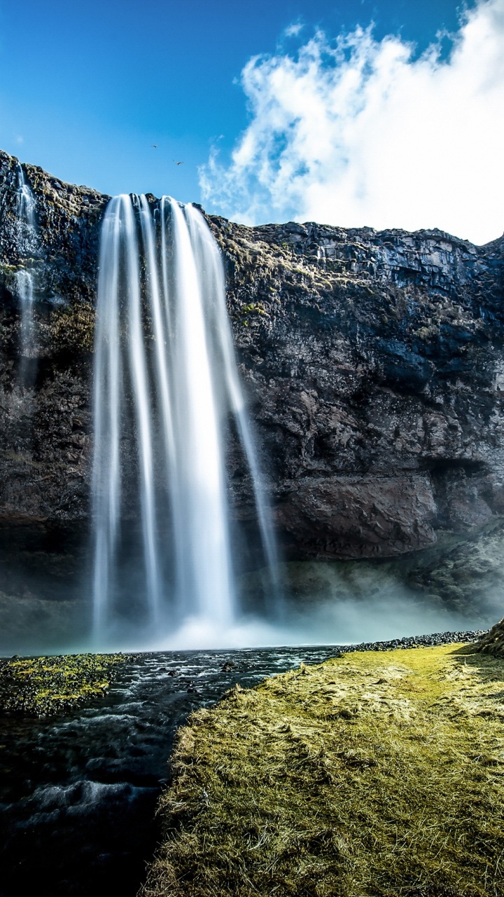 Waterfalls on Green Grass Field Under Blue Sky During Daytime. Wallpaper in 720x1280 Resolution