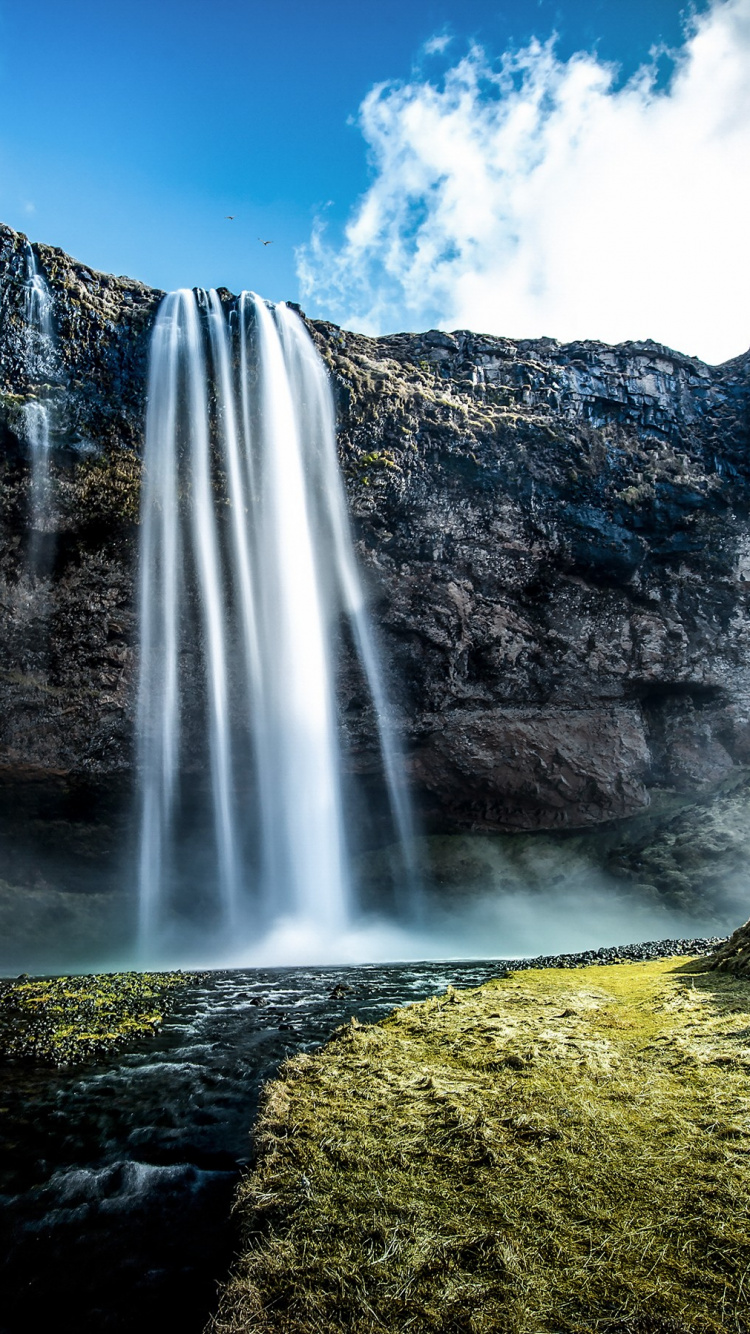 Waterfalls on Green Grass Field Under Blue Sky During Daytime. Wallpaper in 750x1334 Resolution