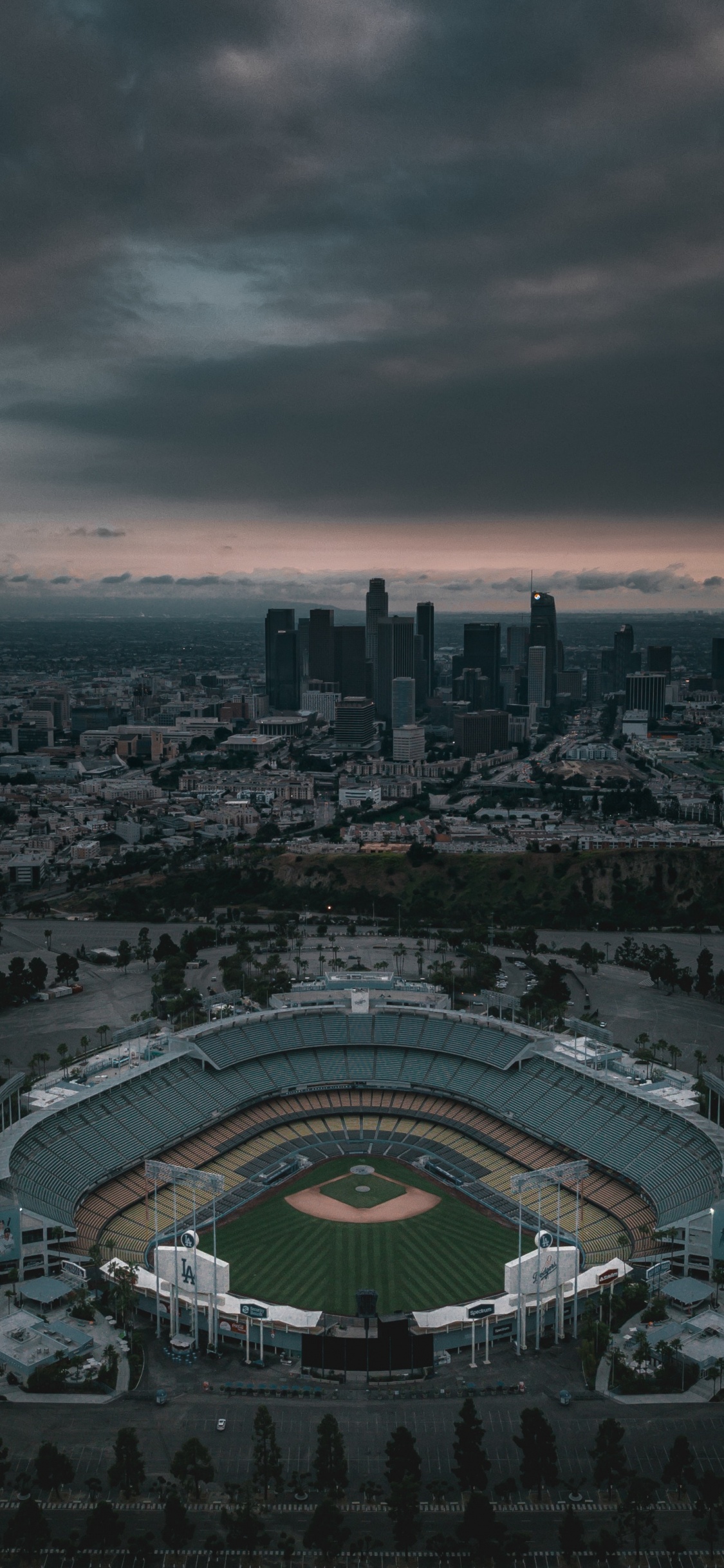 Aerial View of City Buildings During Night Time. Wallpaper in 1125x2436 Resolution