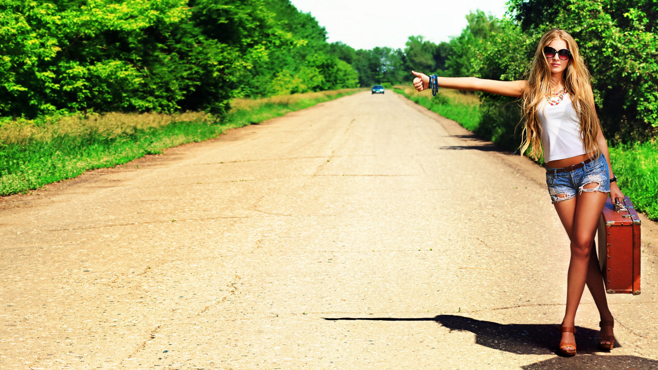 Person in Black Shirt and Blue Denim Jeans Riding Bicycle on Gray Road During Daytime. Wallpaper in 1280x720 Resolution