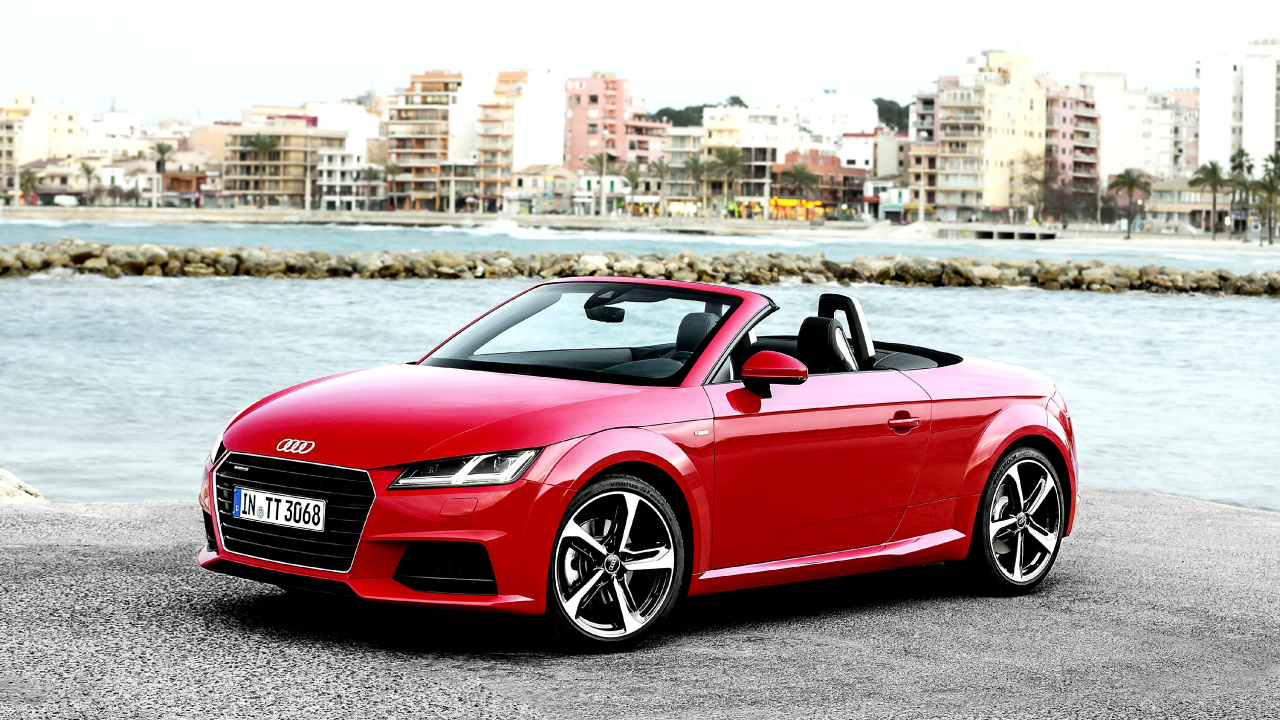 Red Convertible Car Parked Near Body of Water During Daytime. Wallpaper in 1280x720 Resolution