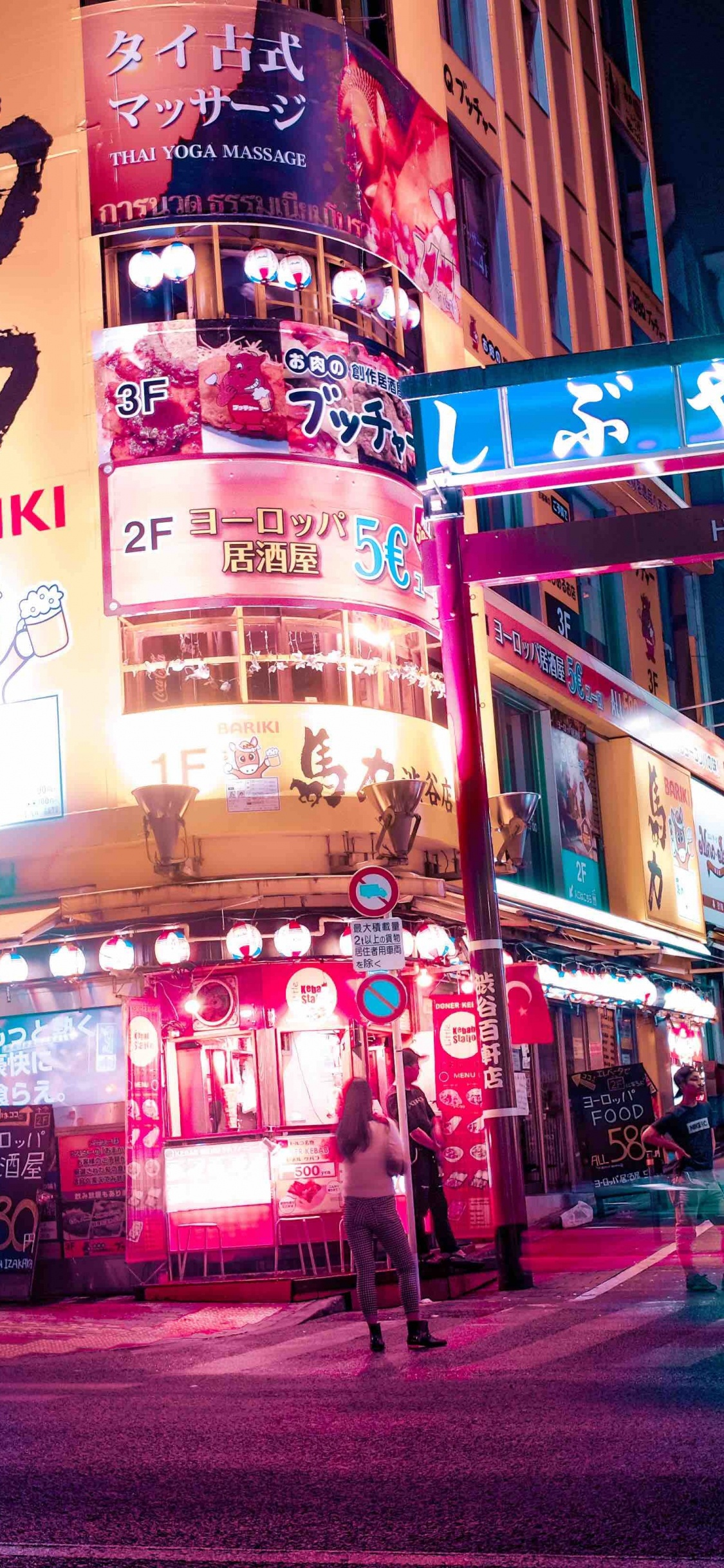 People Walking on Street During Night Time. Wallpaper in 1125x2436 Resolution