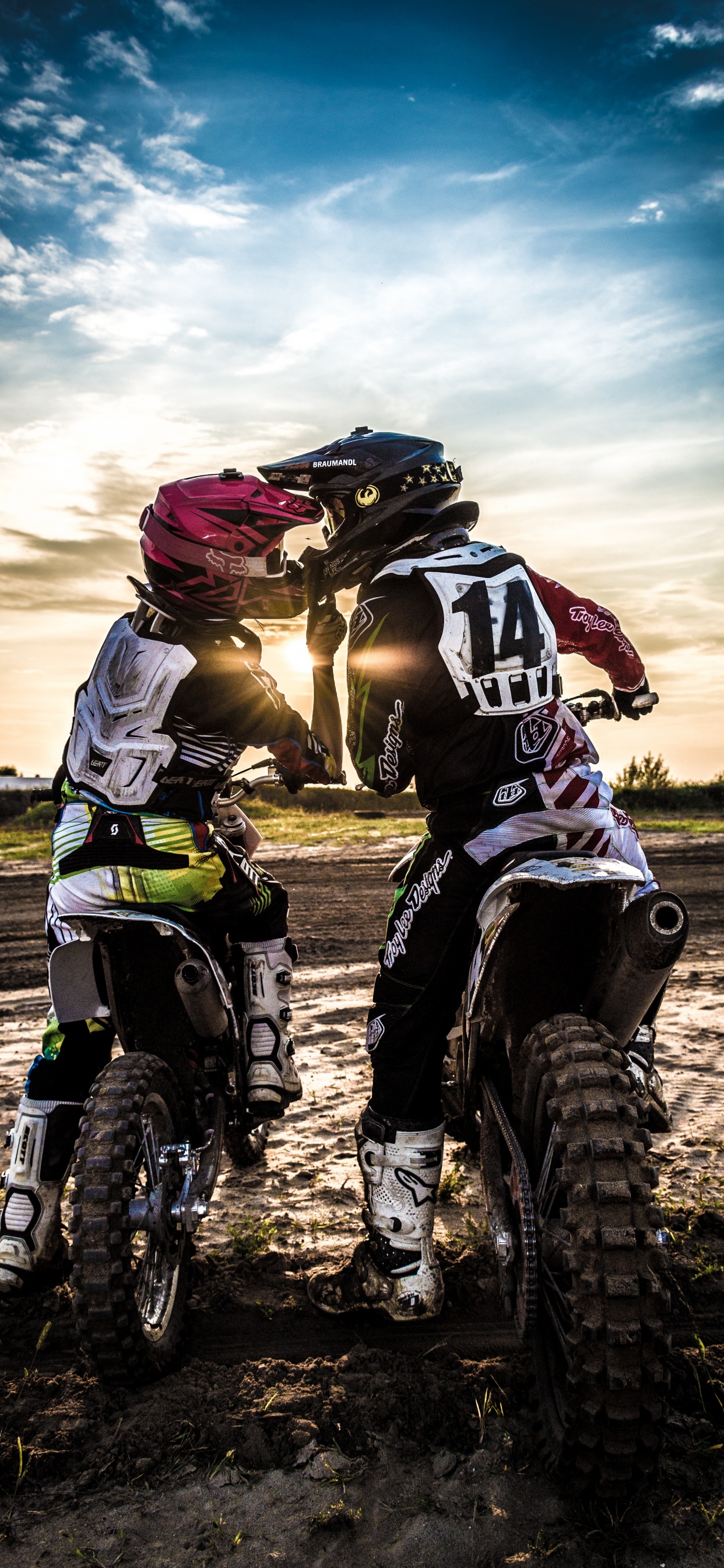 Man in Black and White Motorcycle Suit Riding Motocross Dirt Bike. Wallpaper in 1242x2688 Resolution