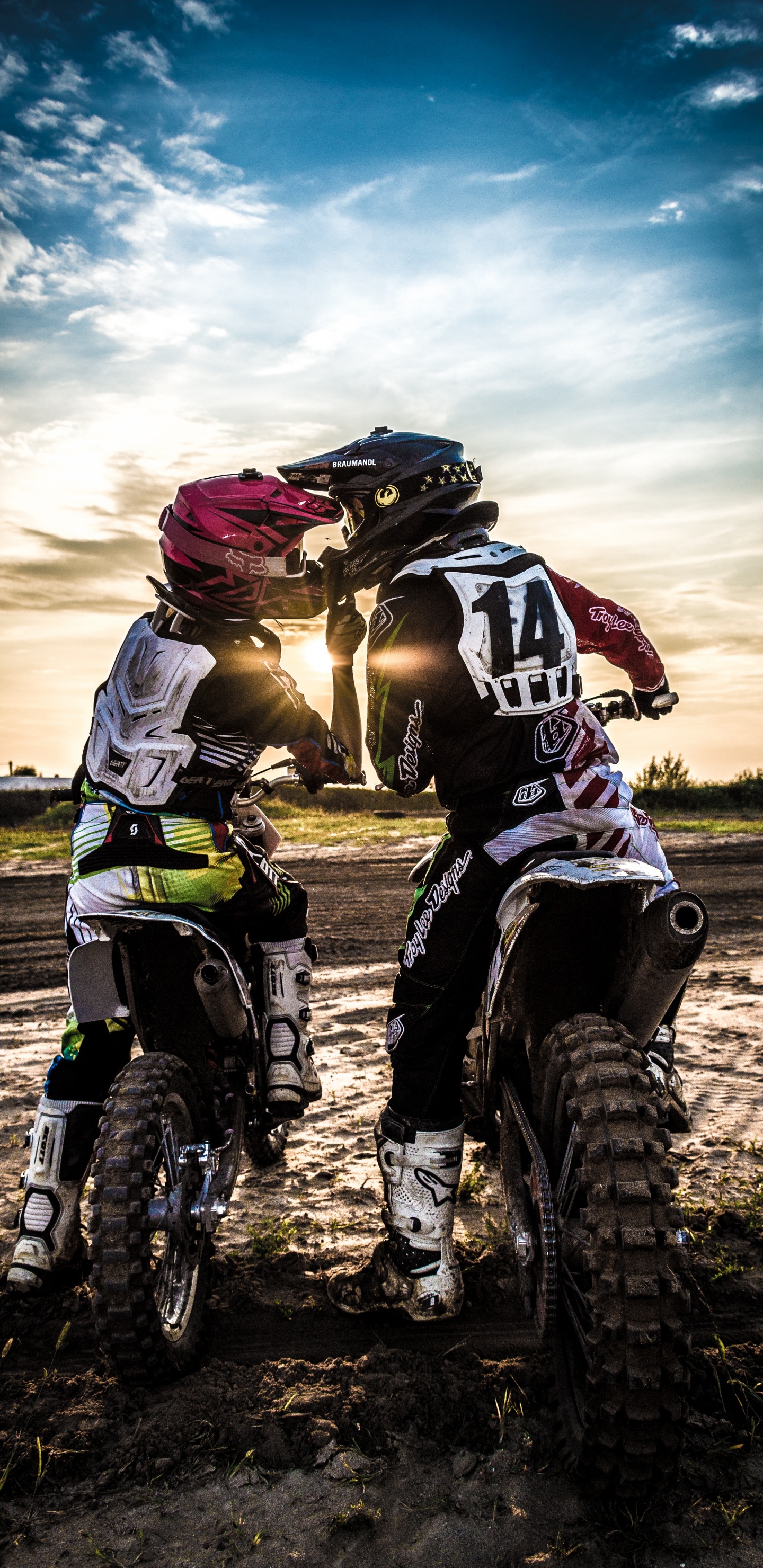Man in Black and White Motorcycle Suit Riding Motocross Dirt Bike. Wallpaper in 1440x2960 Resolution