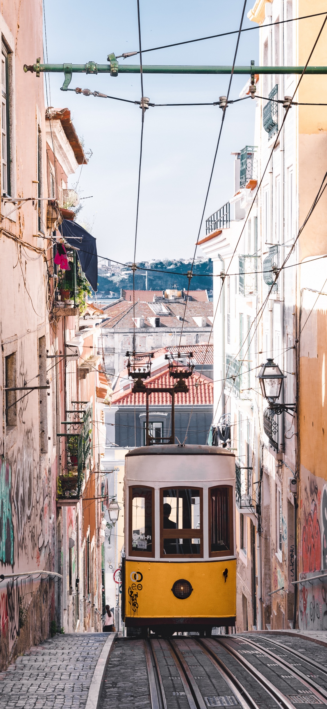 Yellow and Black Tram on Street During Daytime. Wallpaper in 1125x2436 Resolution