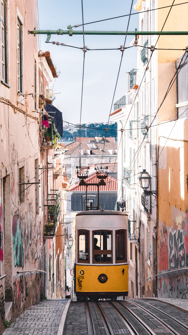 Yellow and Black Tram on Street During Daytime. Wallpaper in 750x1334 Resolution