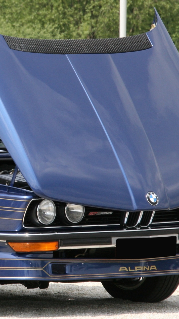 Blue Car on Gray Asphalt Road During Daytime. Wallpaper in 720x1280 Resolution