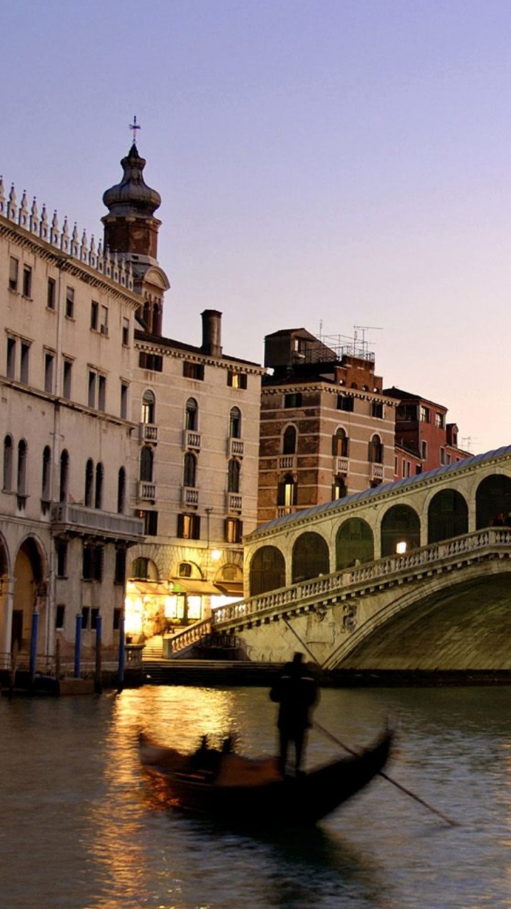 White and Brown Concrete Building Near Body of Water During Daytime. Wallpaper in 720x1280 Resolution