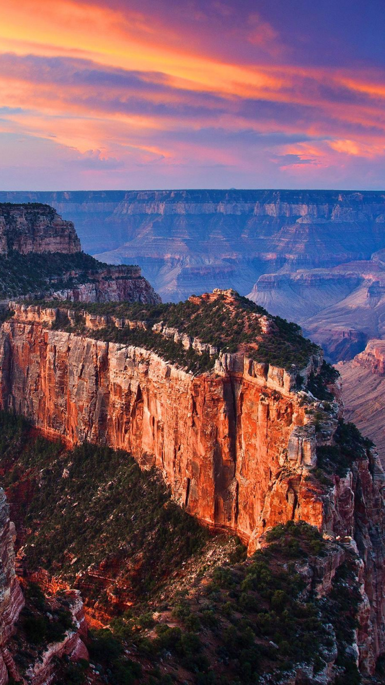 Brown Rocky Mountain Under Cloudy Sky During Daytime. Wallpaper in 750x1334 Resolution