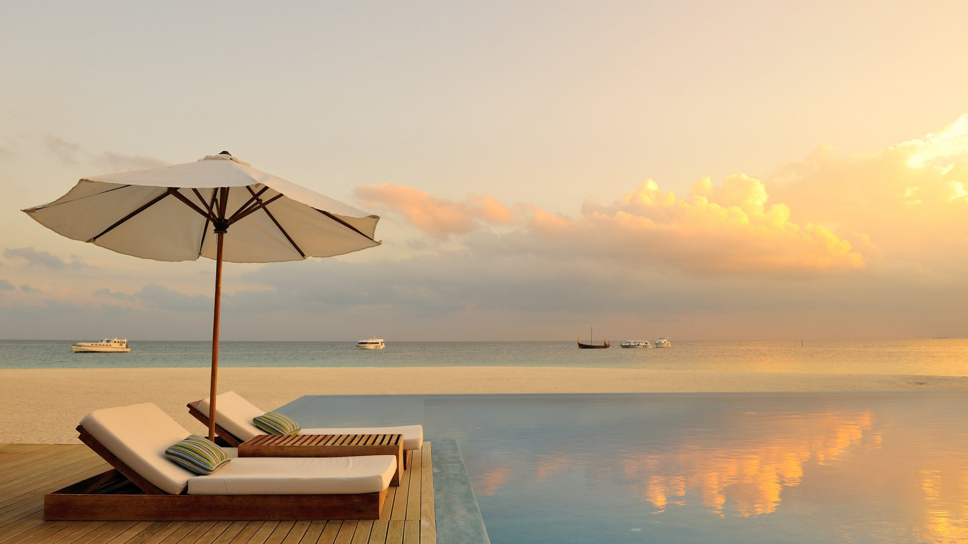 White and Brown Wooden Lounge Chairs on Beach During Daytime. Wallpaper in 1920x1080 Resolution