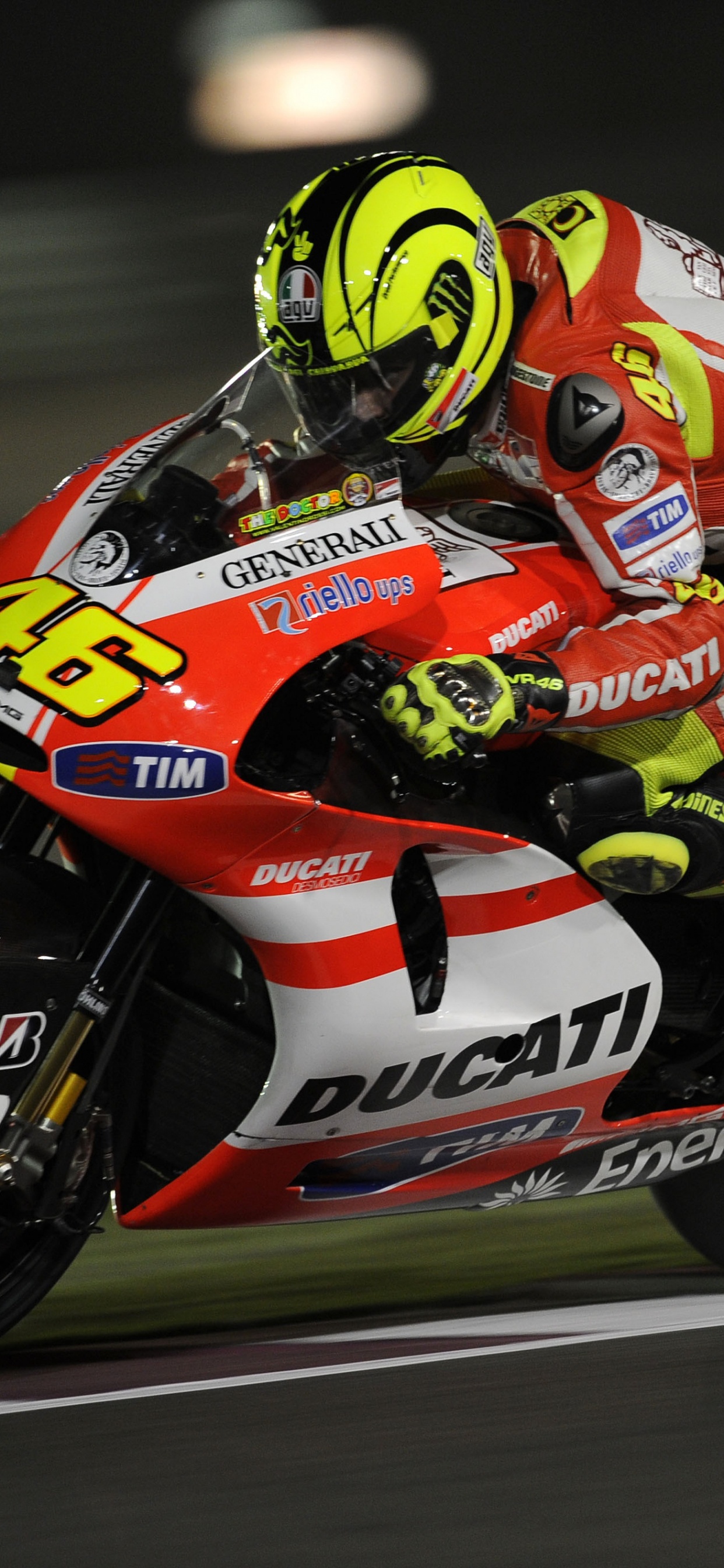 Man in Red and White Racing Suit Riding on Sports Bike. Wallpaper in 1242x2688 Resolution